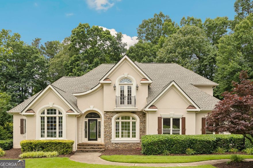 Welcome to the stunning former model home of Deerlake Subdivision in Awesome Alpharetta!  Enjoy all the builder extras including gorgeous, extensive trim work and molding, smooth ceilings & recessed lighting thru-out! All rooms are light & bright with lots of windows offering natural sunlight! The entry features a custom leaded glass front door, sidelights & transom! Located on the main level you will find the Luxurious Primary Suite finished with a double-tray ceiling, a recently remodeled, spa-style retreat Bathroom, a large walk-in shower with pebble reflexology flooring, an extra large Kohler designer soaking tub, a double vanity & 2 walk-in Closets with built-in shelving!  The Main floor Kitchen offers a wine refrigerator, a NEW full-size Refrigerator with custom ice drawers, a NEW cooktop and dishwasher, granite countertops, a deep sink, a large walk-in pantry & an open layout! The ceilings soar in the two-story foyer & living room with a glowing and cozy fireplace!  The Den/Office is located off the main foyer with Built-ins cabinets and a large picture window and transom! The dining room is appointed with modern lighting, French paneled walls and a picturesque view of the front yard through the large double window and transom. At the side entry there is a mud/laundry room with a large utility sink.  Upstairs you will find a large Ensuite guest Bedroom and 2 additional Bedrooms with a connected bath. All bedrooms enjoy spacious walk-in closets!  Hardwood floors adorn the main level while the well appointed terrace level is finished with custom Italian porcelain tile and features a large, custom built Wine Cellar holding approximately 850 bottles and includes a granite pouring/tasting station.  Also on the terrace level you'll find a large kitchenette and bar, a full bath and an entertaining/TV area with a billiard table & fireplace all opening to your covered patio and private back yard!  The Newer roof was installed in 2022! The heating units were replaced in 2023. The main double garage has an epoxy floor, wainscoting with an insulated door and a "quiet" Belt-Drive Lift Master opener with "MyQ" Smart App Technology! There is a wrap-around driveway to the oversized 3rd car garage with tandem parking and a built-in workshop! Plenty of storage throughout that includes 2 attic access points! The front and rear yards have an inground irrigation system! This exterior of the home is finished with hard-coat stucco! The fabulous Deerlake community is golf cart friendly and enjoys a gated main entry and excellent community amenities including a Clubhouse, Olympic-size pool, fun children's pool, 6 tennis/pickleball courts, a basketball, a tot lot, golf cart parking, and a scenic lake with a beautiful fountain and fishing pier! Close to shops &  restaurants! Deerlake is located in Beautiful Forsyth County and enjoys Forsyth County taxes.