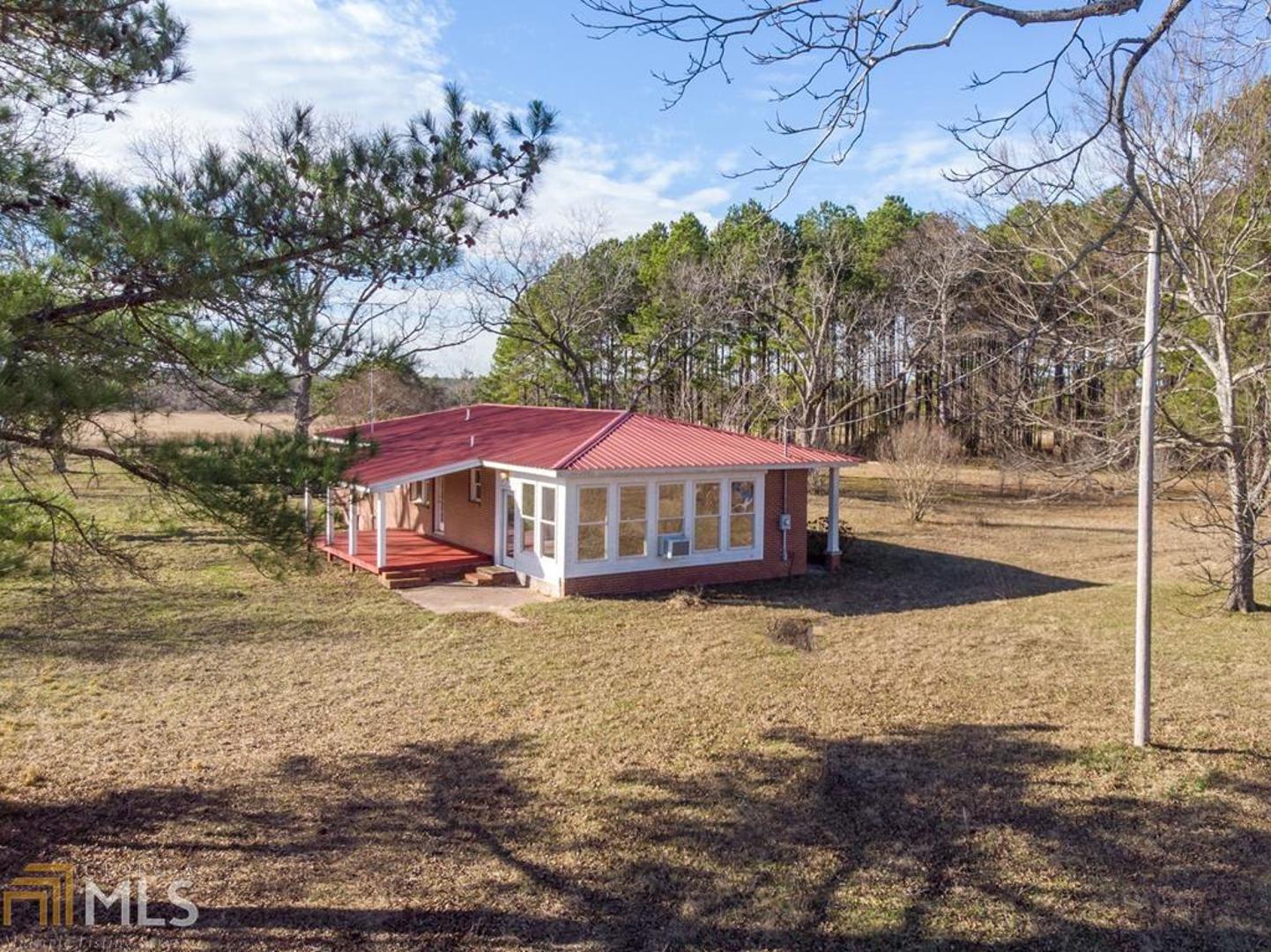 You'll love the view from your front porch! 22 Beautiful level acres of grass land for horses. The brick home sits among pecan trees. It has durable and attractive bamboo flooring and a red tin roof. The kitchen and baths are updated and spacious. The well designed 24 x 124 horse barn has 6 stalls, 12 x 12 tack room, 12 x 36 work room with bath and double wash area. The mechanic and wood working shop is 30 x 48 with 12 foot lean covering on both sides. 24 x 48 hay barn with 9 ft. front door clearance