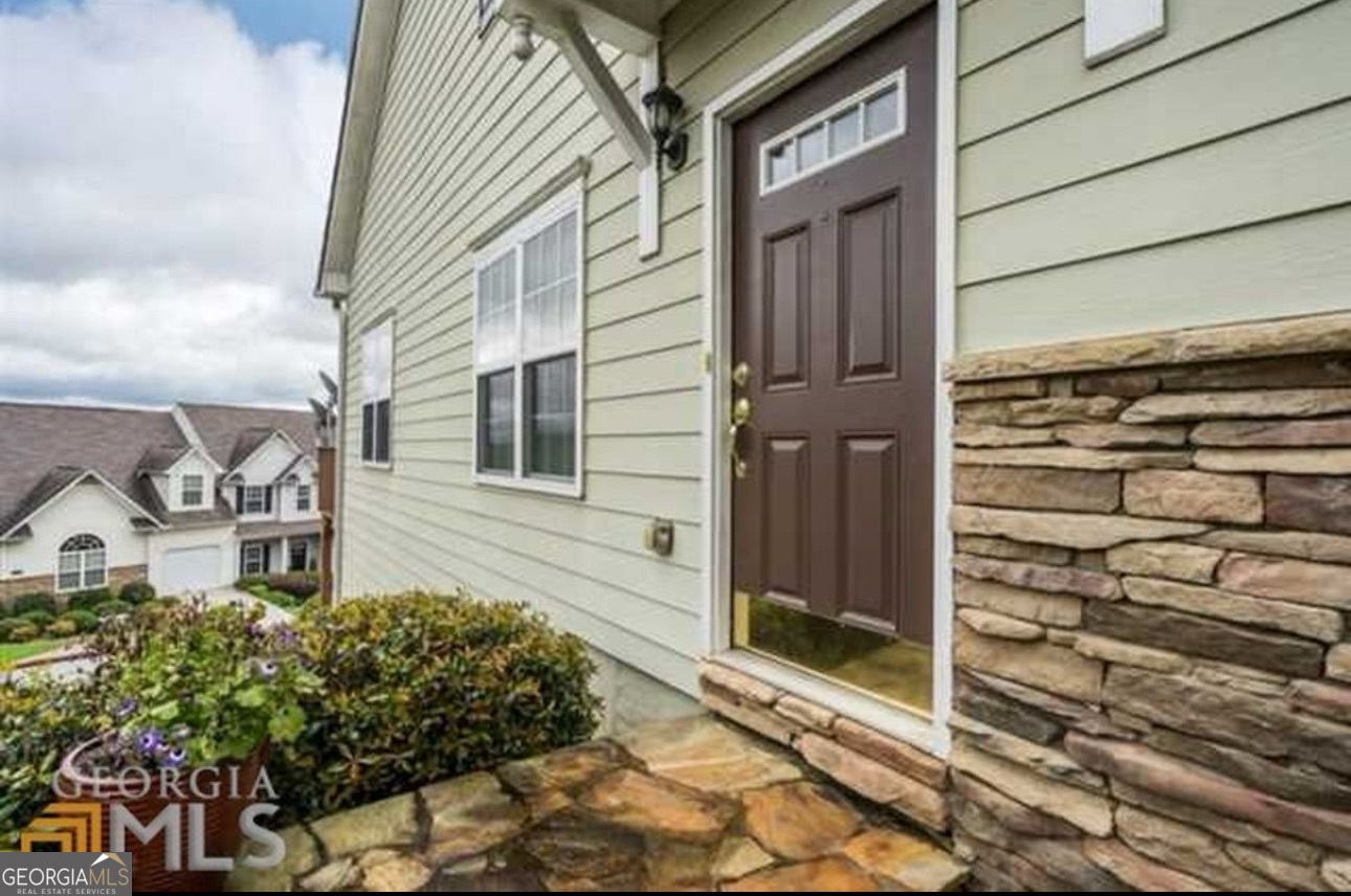 This mountaintop community is conveniently located behind Costco. This is an end unit and offers lots of natural light and an unrestricted view of Kennesaw Mountain from the deck. 10 minutes to KSU. Easy access to I75 and 575. Great subdivision with pool, tennis, basketball, playground & clubhouse. Main level has REAL HARDWOOD floors, not engineered planks. Master bath remodeled with custom frameless shower door, REAL tiled shower floor, not fiberglass shower pan. Floor to ceiling tile behind vanity. Bedroom with double windows and walk-in closet. Large two story greatroom with view to upper level loft. Coat closet Kitchen with newer appliances, upgraded sink and cooking range vented to outside. Kitchen level parking garage. Upper floor has bedroom. full bath, 2 walk-in closets, linen closet, and large loft area. Terrace level has large living area, bedroom with double windows, double french door leading to patio, walk in closet, linen closet, new toilet and vanity. Large bonus room with laundry area. All terrace level has luxury vinyl plank flooring. Oak stair treads leading up to main level. Included in HOA is water, trash, exterior and roof, yard and gutter maintenance. Extra parking pad. Master insurance policy in place through HOA.