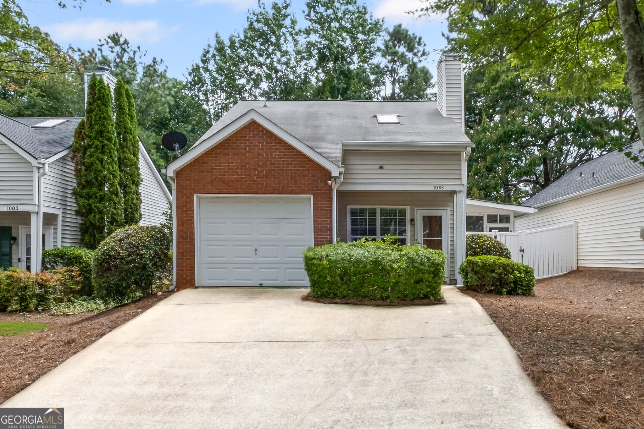 Welcome to this charming brick-front ranch home, perfectly situated in a quiet neighborhood with sidewalks and top-rated schools. Offering an open floor plan, a master and all living area on the main and stainless appliances, this home is designed for comfort and convenience. The spacious sunroom is ideal for enjoying your morning coffee or relaxing with a good book, while the large upstairs bonus room provides endless possibilities as a bedroom, media room, or office. A cozy fireplace anchors the main living space, and the vinyl-fenced private backyard is complete with paver walkways and an outbuilding for extra storage. The HOA maintains the front lawn, making this very low-maintenance home truly move-in ready. Enjoy a one-car garage, a bright and airy layout, and a prime location just off Bells Ferry Road and Eagle Drive-only minutes from the shopping, dining, and attractions of downtown Woodstock and the natural beauty of Lake Allatoona. This is the perfect blend of convenience, comfort, and easy living.