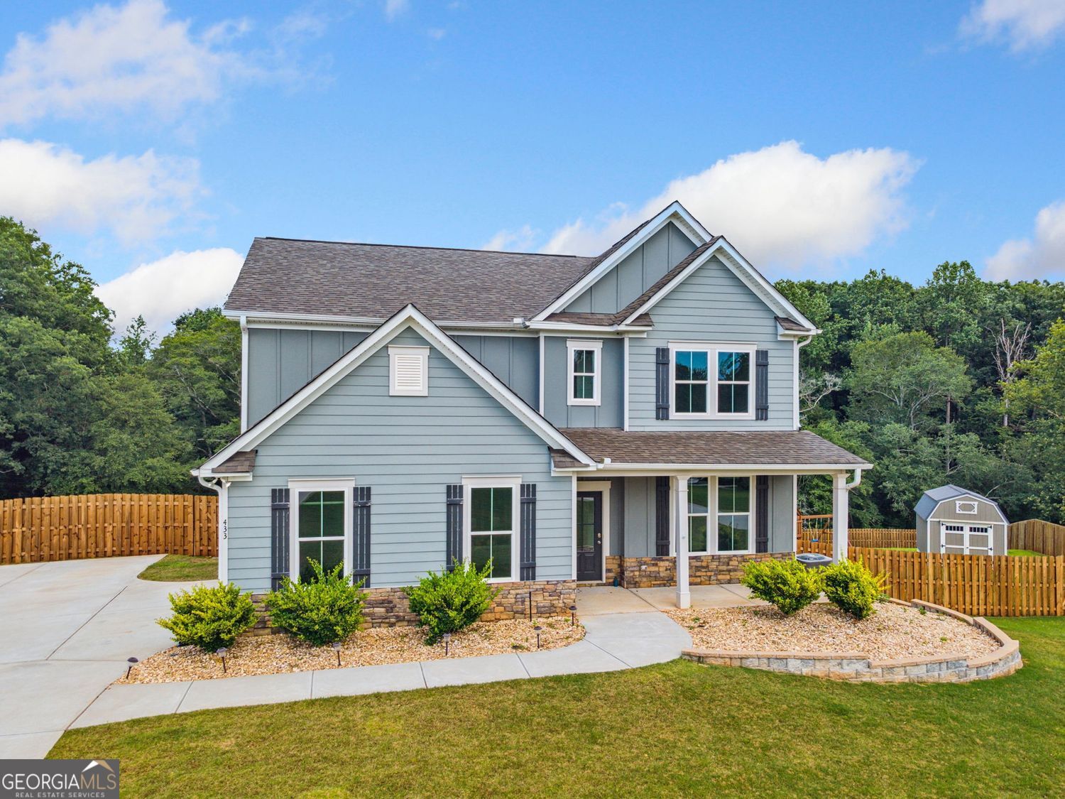 Elegant Comfort Meets Natural Serenity - Spacious 4BR/3BA on 1.49 Acres in Cornelia. Tucked away in a peaceful cul-de-sac on a sprawling 1.49-acre lot, this stunning 4-bedroom, 3-bathroom home blends timeless elegance with everyday comfort in scenic Habersham County. Just minutes from the mountains, you'll enjoy the beauty of mature trees, a meandering creek, and breathtaking views-all in a tranquil setting with minimal traffic. From the charming covered front porch to the sun-filled interior, every detail invites you in. The main level showcases 9-foot ceilings and durable luxury vinyl flooring throughout the main living areas. A formal dining room provides the perfect backdrop for entertaining, while the spacious family room features a cozy stacked stone fireplace that anchors the space. The open-concept kitchen is a chef's delight, boasting a large granite island, ample cabinetry, and a bright breakfast nook that flows seamlessly into the main living area. A full guest suite on the main floor adds versatility-ideal for visitors, a home office, or playroom. Upstairs, a generous loft landing offers space for a second living area, home gym, or media room. The luxurious primary suite is a serene retreat, complete with tray ceilings, a spa-style bathroom with dual vanities, an oversized tiled shower, and an expansive walk-in closet. Two additional bedrooms share a beautifully updated bath with granite counters and dual sinks. Step outside to the covered back deck and take in the peaceful view of the tree-lined creek beyond the fully fenced backyard. A staircase leads down to a wide green space-perfect for gardening, play, or outdoor entertaining-with a storage building ready for your tools and gear. Offering refined finishes, a flexible floor plan, and serene outdoor living, this exceptional Cornelia home is the perfect blend of space, style, and nature-just a short drive from mountain escapes and everyday amenities.