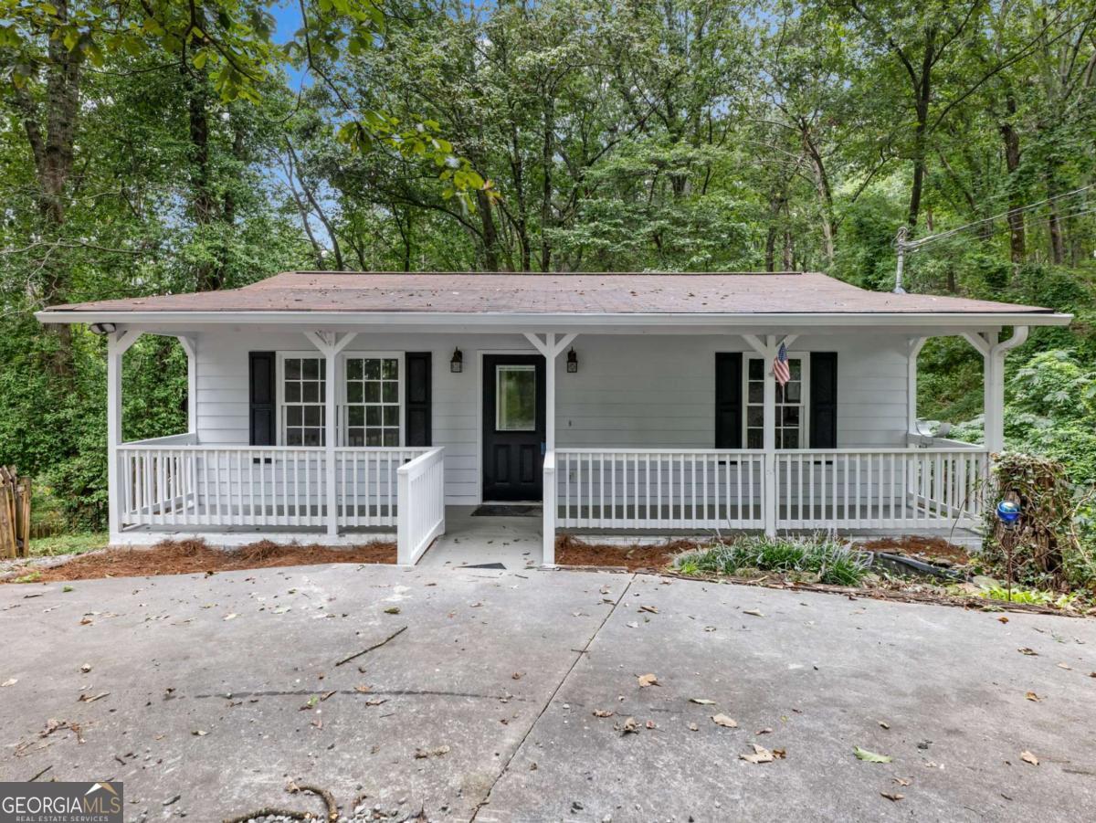 This sweet cabin/bungalow is perfect for your getaway or for full-time living. Tile floors in the Living Room, Kitchen, and upper bath. Large Laundry room in the basement. Second room in the basement could be used as an office or for storage. Enought room on the front porch to relax in your rocking chair. There are back decks off both the main floor and the lower level. Storage building with a screened room for outdoor fun. Concrete circular driveway way. Convenient to Cleveland & Gainesville. Seasonal views.