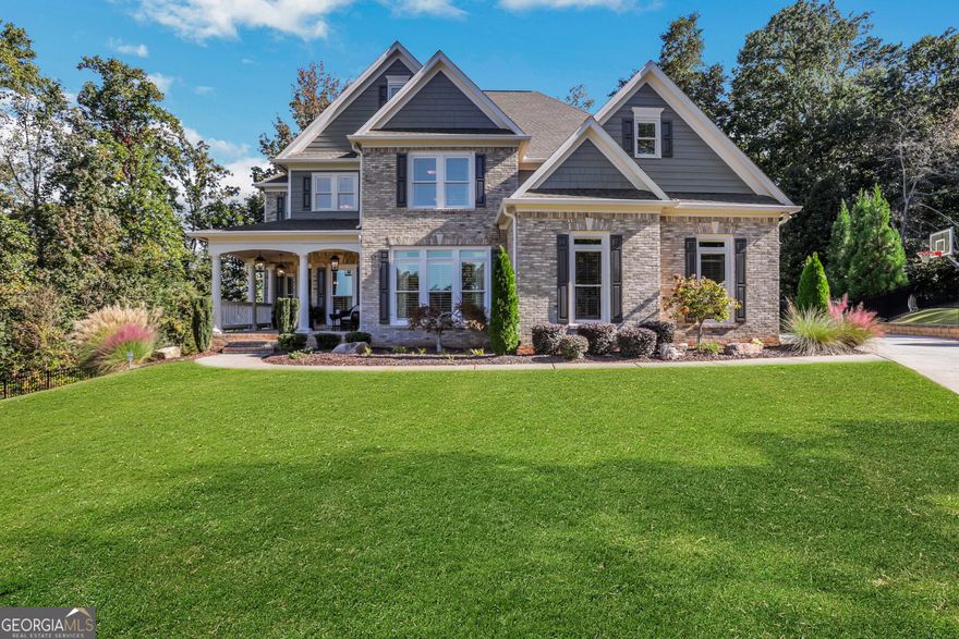 Tucked away on a peaceful cul-de-sac, this meticulously maintained 3-sides brick home stands out with its timeless curb appeal, inviting front porch, and incredible outdoor oasis. Step inside to rich hardwood floors, soaring ceilings, and walls of windows that fill the home with natural light. The main level offers a private office-perfect for working from home-and an elegant dining room ideal for hosting family and friends. At the heart of the home, the updated kitchen impresses with quartz countertops, high-end stainless steel appliances, and an extended island that opens seamlessly to the two-story great room. It's the kind of space that makes both everyday living and entertaining feel effortless. Upstairs, the spacious primary suite is a true retreat with a spa-inspired bath, soaking tub, oversized glass shower, dual vanities, and a large walk-in closet. Three additional bedrooms-one with a private ensuite and two sharing a Jack-and-Jill bath-offer comfort and flexibility for everyone. Also upstairs you'll find the laundry room. The fully finished basement is designed for fun and function with a game room, full kitchen, bedroom suite, ample storage, and the best home theater on the market-complete with stadium seating. Step outside and enjoy your own private backyard oasis with sparkling pool, waterfall feature, oversized hot tub, screened-in deck, and side porch. A tankless water heater, 3 car side-entry garage and thoughtful updates throughout make this home as efficient as it is beautiful. Located in Ashebrooke, one of the area's most vibrant and social communities, known for holiday celebrations, pool parties, tennis leagues, and neighborhood gatherings. Just minutes from Big Creek Greenway, Cumming City Center, GA 400, shopping, dining, and top-rated West Forsyth schools. More than a house-this is a place where life slows down, laughter comes easily, and memories are made to last.