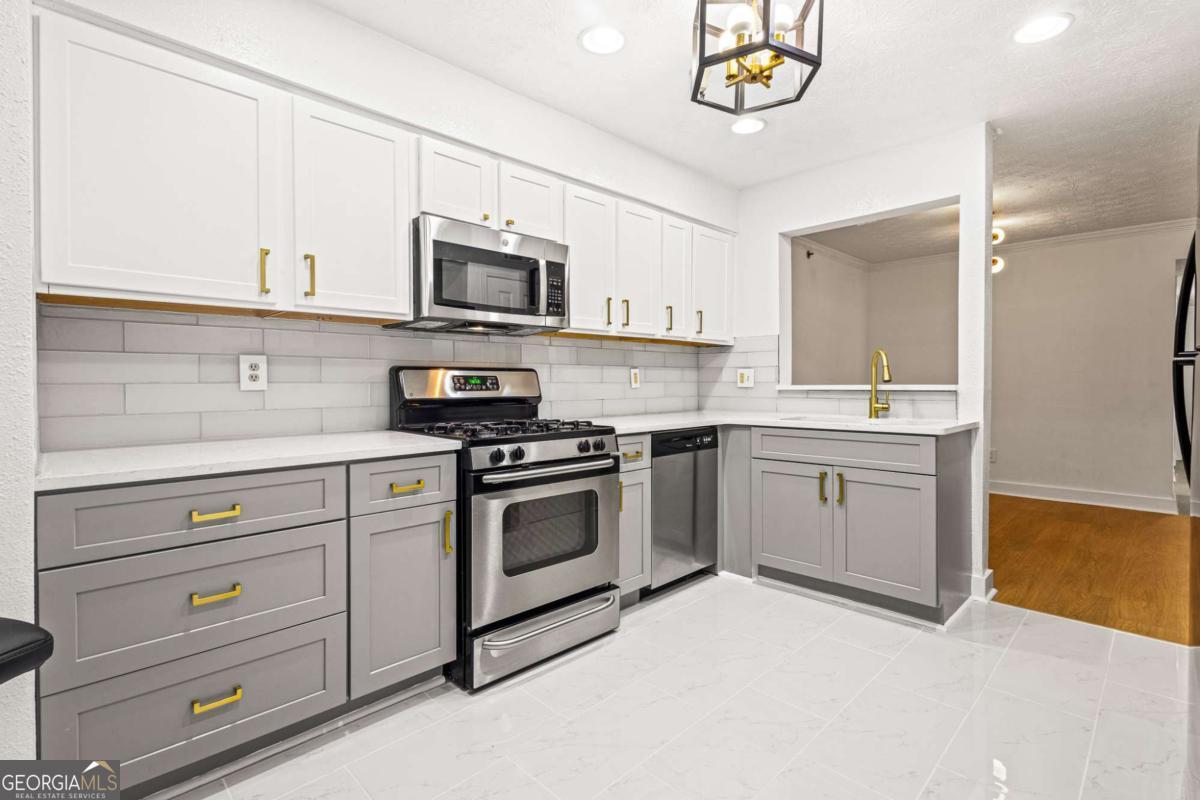 Welcome Home - Where style, comfort, and functionality come together seamlessly. This spacious, STEPLESS home offers effortless living with a fully renovated interior that's move-in ready. Step inside to discover an open-concept layout filled with natural light, luxury vinyl plank (LVP) flooring throughout and a cozy fireplace that anchors the living space. The updated kitchen is a true showstopper, boasting modern finishes, ample cabinetry, and plenty of room for cooking and entertaining. Work from home? You'll love the dedicated office space-quiet, private, and perfect for productivity. Both bathrooms have been tastefully updated; completing the list of improvements. (And) when it's time to relax, step out onto the screened porch to enjoy your morning coffee or unwind with an evening breeze. Enjoy the many conveniences you'll have access to such as Chattahoochee River National Recreation Area and Sope Creek Trails that's perfect for walking, running, and biking. The Avenue East Cobb and Cumberland Mall offers plenty of retail, dining and entertainment options close to home. This home is more than move-in ready, but ready for your next move! Schedule your tour today to see this gem in the heart of Marietta!
