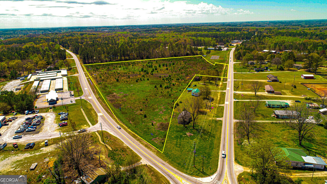 Located in Covington, Newton County Highly visible corner lot with 14.45 acres in Covington at the souther corner of Hwy 212 & 36. Zoning for 3.96 Acres is CN (south side) Zoning for 10.49 Acres is AR (north side) Round About it place Zoning and Permitted Uses in Documents pages 349- 372 Utilities - Water, Electric, NO Sewer
