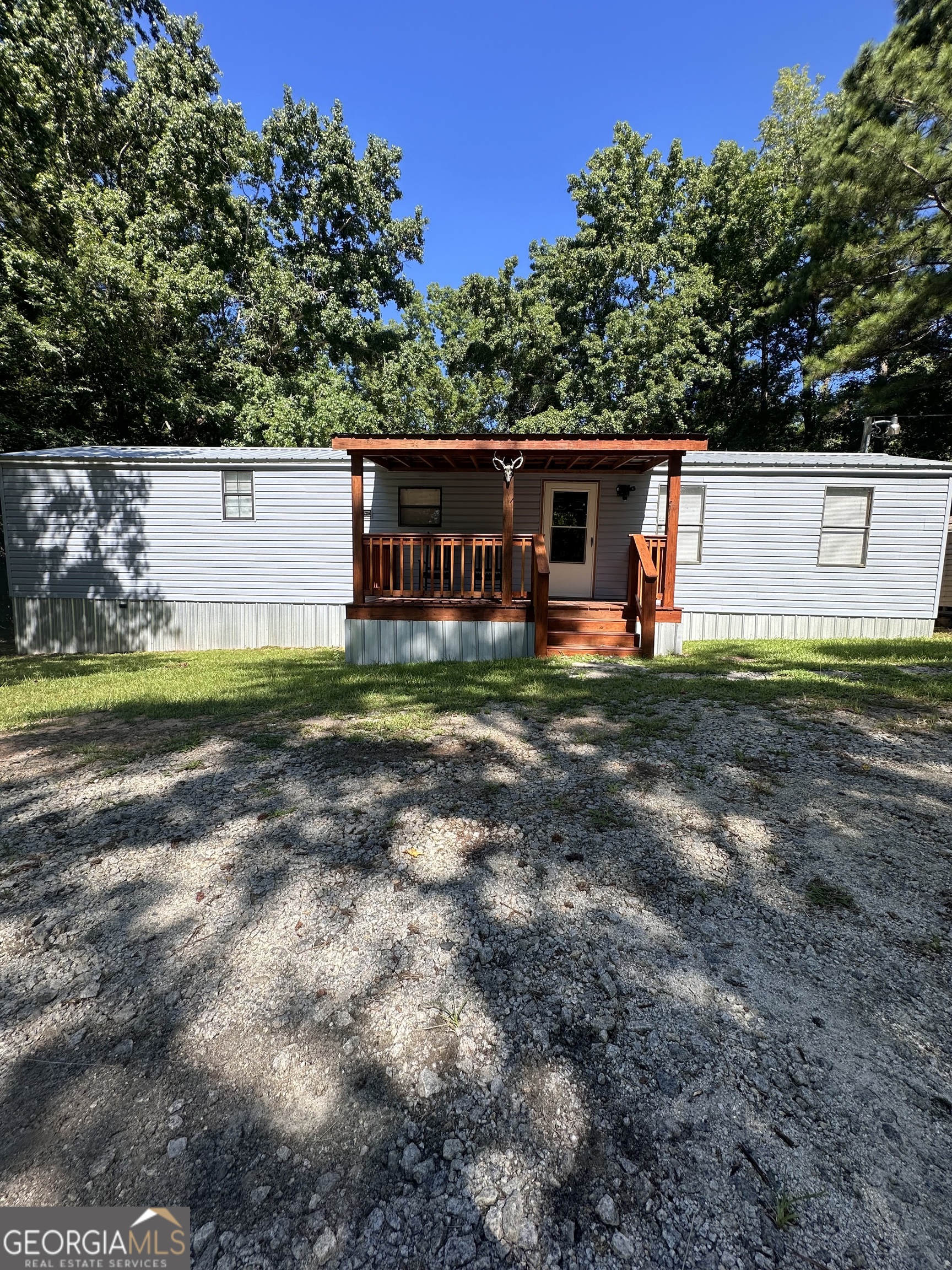 Great opportunity on Stembridge Road! This updated mobile home sits on 2 acres and is only 5 minutes to downtown Milledgeville. There is a carport, shed, and dog kennels that will convey with the property. This home has all new siding, a new roof, flooring, plumbing and electrical. Kitchen and bath has been updated as well. The water heater was replaced in 2022. The manufactured home title has been retired and is now real property. Showing by appointment only.