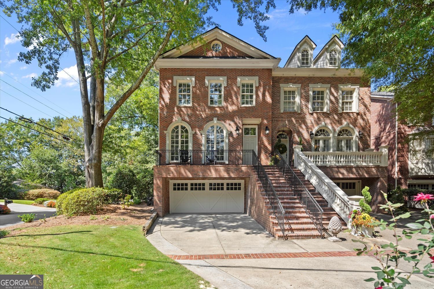 Luxurious Buckhead living at 604 Timm Valley Rd NE, Unit A on a quiet street in Atlanta's Peachtree Park. This upscale Buckhead townhome offers the ease of a townhouse with the feel of a luxury single-family home. Enjoy 10-foot ceilings, wide-plank hardwoods, and an open, bright floor plan perfect for entertaining. The chef's kitchen features a walk-in pantry, quartz counters, custom cabinetry, professional-grade appliances, and an oversized island. From the living room, step onto the back deck where newly installed stairs lead to a large fenced backyard, a rare Buckhead feature. The new stairs to the backyard will be stained once the wood has fully acclimated. The oversized primary suite includes two walk-in closets and a spa bath with soaking tub, frameless shower, and dual vanities. Secondary bedrooms are versatile, while the terrace level offers a wet bar, recreation/media space, and two-car garage. Recent updates include a roof and dual HVAC systems just 2-3 years old. Minutes to PATH400 Greenway Trail, Chastain Park, Buckhead Village, and Lenox Square shopping and dining.