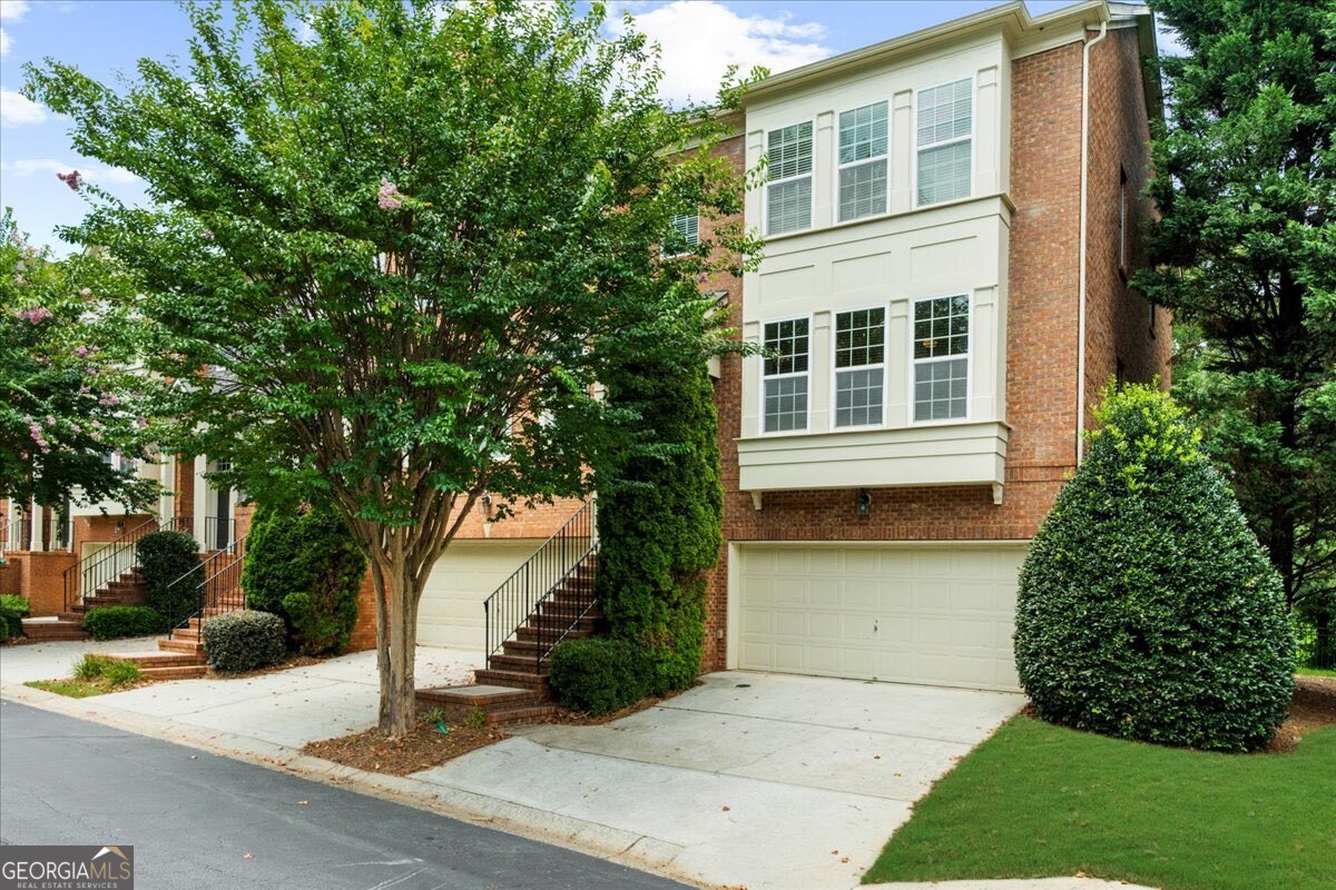 BEST LOCATION IN SMYRNA right on the East-West connector without the noise! Lots of natural light throughout home. This stunning END UNIT is conveniently located close to Truist Park, The Battery, Cumberland Mall, Cobb Galleria, Costco, Starbucks and so much more. Easy access to I-285, I-75 & I-20. Enjoy direct access to the Silver Comet Trail right at the front of the neighborhood, perfect for walking, biking, and outdoor adventures. Spacious, open layout that's great for entertaining indoors and AMAZING VIEWS from the private back deck overlooking greenary. Home is across from the pool, mailboxes and guest parking making it THE BEST location in the community. You cannot beat this location!! Water heater 2024, new carpet, new hardwoods on main level and beautiful hardwood stairs.