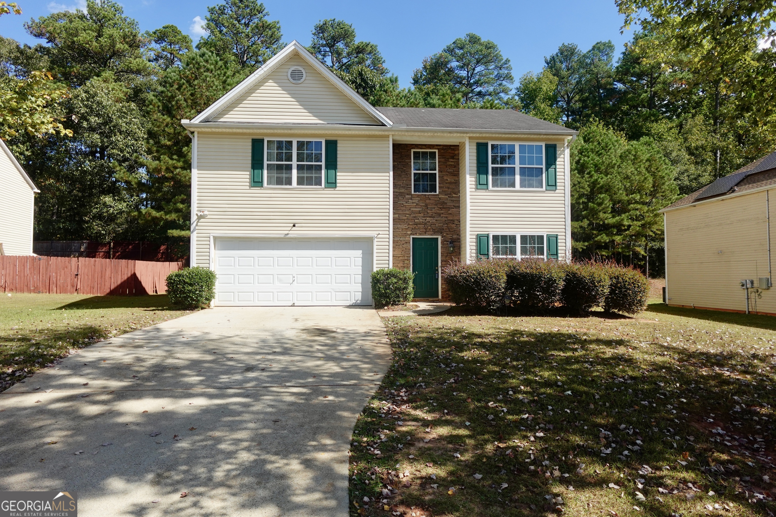 This 4-bedroom, 2.5-bath home offers nearly 2,500 square feet of comfortable living space, ideal for first-time buyers or investors seeking a property with great potential. You're greeted by a grand two-story foyer leading to a separate dining room that overlooks the family room with a cozy fireplace. The oversized kitchen provides ample counter space, generous storage, and easy access to the back deck, perfect for outdoor gatherings or morning coffee. Upstairs features an intimate loft overlooking the foyer, along with spacious secondary bedrooms-each with walk-in closets. The primary suite faces the front of the home and showcases large windows, tray ceilings, and two walk-in closets, plus a separate soaking tub and shower for a true retreat experience. Located just minutes from Camp Creek Marketplace, Wolf Creek Amphitheater, and the Amazon Fulfillment Center, this home offers comfort, convenience, and endless opportunity to make it your own.