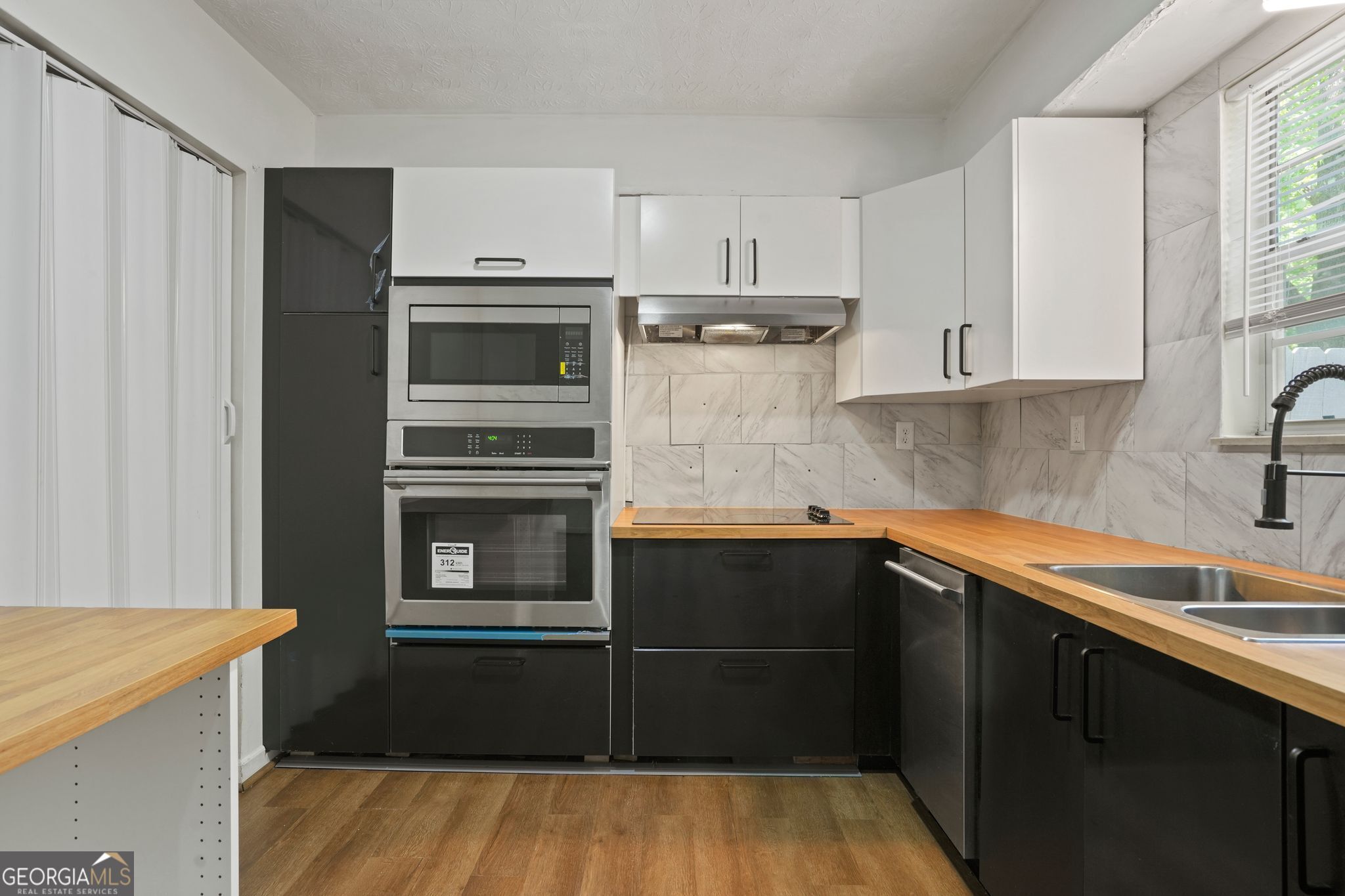Experience contemporary living in this fully renovated three-bedroom, one-and-one-half bath, two-story condo. Enjoy updated bathrooms, a modern kitchen boasting a fresh countertop, sink, and faucet, complemented by vinyl plank flooring on the first floor and in baths, and plush carpeting in second-floor bedrooms. Light fixtures illuminate the space, while a new water heater ensures comfort year-round. Additional features include convenient storage under stairs, a private fenced patio area, and new window blinds throughout. Don't miss out on this stylish and convenient condo offering.