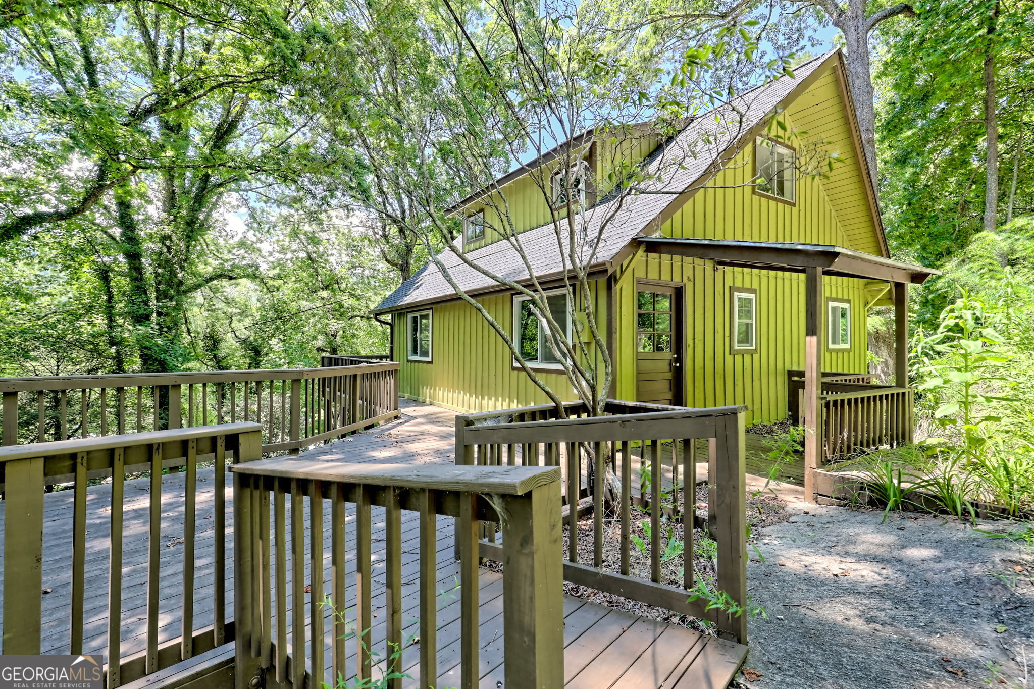 This quaint cabin in Mountain City is ready for its new owner. Nestled in a quiet residential neighborhood yet walkable to the Mountain City Playhouse and other nearby businesses. Perfect for a starter home or for roommates. Use the interior space in whatever way makes sense for you with a primary bedroom on the main, spiral staircase access to the upstairs with its own bedroom plus a space that could be used as a living room, office, or exercise room or potentially two bedrooms. The lower level has its own bath and a den, game room or could be used as a third bedroom. Low maintenance yard with seasonal mountain views (Black Rock Mountain). Recently renovated with LVP floors, remodeled bathrooms, paint inside & out and decks. For investors it offers income and appreciation potential. Use caution when turning around as the driveway is narrow in a couple of places.