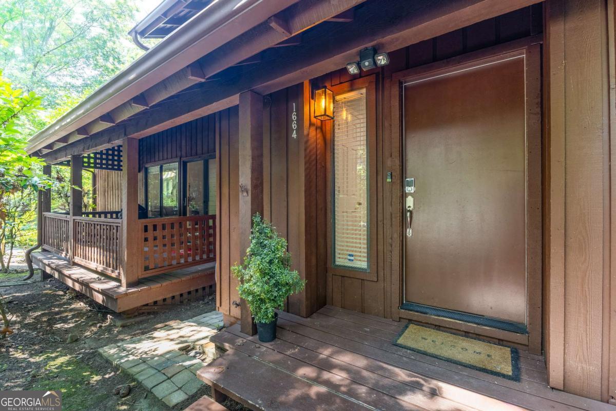 If you could have it all, this is it. LOCATION, CONVENIENCE, PRIVACY and PRICE! Nestled in a secluded wooded neighborhood, this 3 bedroom, 3 bath condo features 2 primary bedroom suites each with a private bath. The sprawling condo offers a beautiful family room with a vaulted/beamed ceiling, separate dining room, eat in kitchen, 3 decks (yes count them, 3), closets galore and a full laundry room. And if that's not enough, all appliances are included: Refrigerator, range, dishwasher, microwave, wine cooler, washer and dryer. New carpet and new paint makes this a truly move in ready special. All you have to decide on, is what near by activities you want to enjoy. Braves, concerts, Chattahoochee river, hiking/biking trails, restaurants all just minutes away. Don't let this one get away.