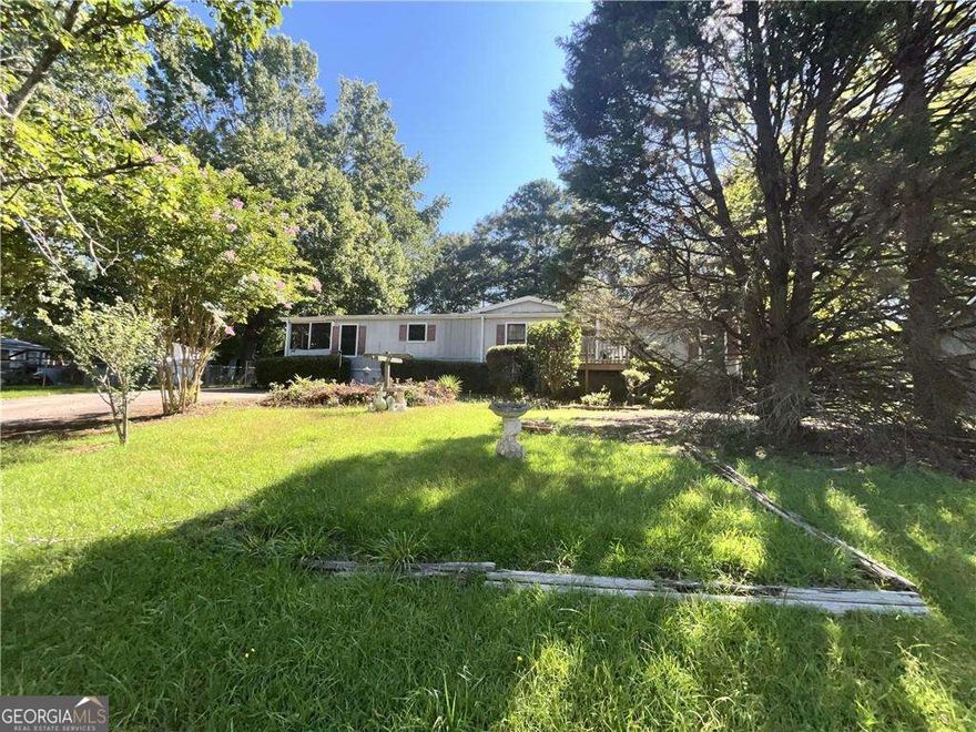 Double wide, 3 bedroom 2 bath and detached 2 car garage/storage. Fenced in yard.