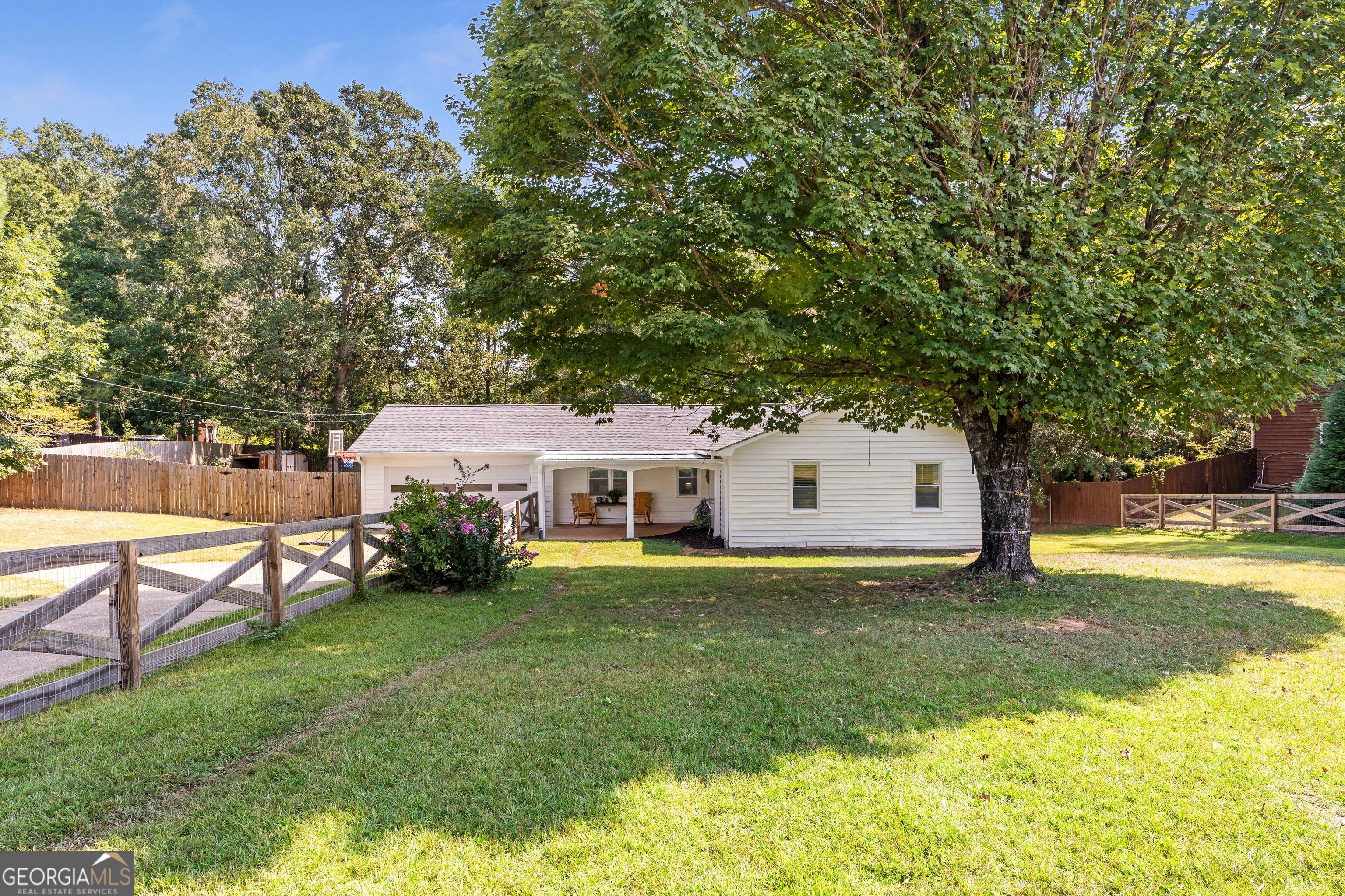 Picturesque ranch on over half an acre in LAKE LANIER ACCESS neighborhood w/no HOA! This charming 3BR/2BA home features newly painted interior and exterior, new floors throughout, large living room with vaulted ceilings, newly renovated secondary bath, open kitchen with new appliances and more. Enjoy coffee on the private back porch overlooking large, cleared backyard with recently added privacy fence. Plenty of storage in 2 car garage for all your water toys and double gate access to allow room in the back for boat. Walk to Little Ridge Park with boat ramp and pet friendly trails that run along the shoreline. Minutes to shopping, restaurants, parks, etc. This home has it all!