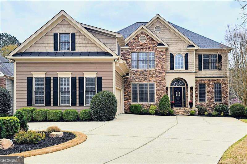 Just a short walk from the Bentwater Golf Clubhouse, and located in the desirable North Paulding High School district, this spacious and beautifully maintained 6-bedroom, 4-bathroom home on a prime cul-de-sac lot overlooking the 9th fairway in the sought-after Bentwater community is a MUST SEE! The main level features a welcoming two-story foyer, separate formal living and dining rooms, a guest bedroom with a full bath, and an open-concept family room with a cozy fireplace and custom built-ins. The bright and spacious eat-in kitchen is perfect for entertaining, featuring a large center island that seats five, granite counters, stainless steel appliances, and a breakfast area with beautiful views of the golf course. Adjacent to the kitchen, you'll find a large pantry, mudroom, full laundry room, and a kitchen-level 2-car garage with an additional parking pad-ideal for a third vehicle or golf cart. Upstairs, you'll find four generously sized bedrooms and two full bathrooms. The oversized primary suite includes a spa-inspired ensuite with double vanities, a soaking tub, separate shower, and an expansive walk-in closet-complete with a convenient laundry chute to the main level. The fully finished terrace level offers excellent versatility, featuring a media room, game room, sixth bedroom, full bath, and an additional flex space perfect for a home gym, office, or workshop. The basement also includes additional laundry hookups for added functionality. Enjoy the outdoors with multiple inviting living spaces, including a back deck overlooking the fairway, a covered patio below, a playset, and a beautifully landscaped fully-fenced backyard with room to gather, grill, and relax. As a Bentwater resident, you'll enjoy resort-style amenities including a clubhouse, Jr. Olympic swimming pool plus four additional neighborhood pools, a splash park, multiple playgrounds, tennis and pickleball courts, basketball courts, miles of walking trails, and expansive community green space. Ideally located just under 0.5 miles from the intersection of Graves Road and Cedarcrest Road, 2.5 miles from Hwy 41, and approximately 7 miles from I-75. Grocery stores, restaurants, gas stations, fitness centers, and highly rated schools are all nearby, making 174 Waterstone Pointe a rare opportunity to enjoy both convenience and an elevated lifestyle in one of Acworth's premier golf course communities.