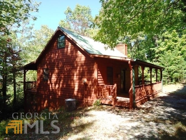 "What everyone wants" 2BR, 2BA cabin in the woods with over 1,000 acres of national forest right out the front door! Take in the year-round MEGA views from the back porch. Cabin features wide plank ponderosa pine walls, tongue and groove pine ceilings, beautiful wood floors and a vaulted ceiling in the den with exposed cedar beams. Cozy up to the wood burning rock fireplace during the cooler months. Master on the main with a full bath, plus a sleeping loft above as well. Downstairs you will find a full basement with a second den or entertainment area (great space for kids). A full bath is in the basement plus a large mechanical/storage room used for hobbies or extra storage. Outside you will find the peacefulness of the end of the road privacy and the canopy of trees provided by the national forest!