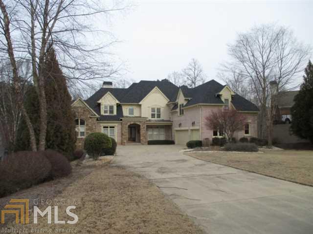 Luxury Lake Home in Gated Community. Double slip dock permit. Open floor plan, gourmet kitchen with island & bar, keeping room w/fireplace, formal dining and living room w/floor to ceiling windows over looking beautiful gunite pool & spa, lake views, master on the main, 3 levels of living, all bedrooms have a private bath, four fireplaces, finished terrace level w/bar & wine cellar, 3 car garage and much more must see.