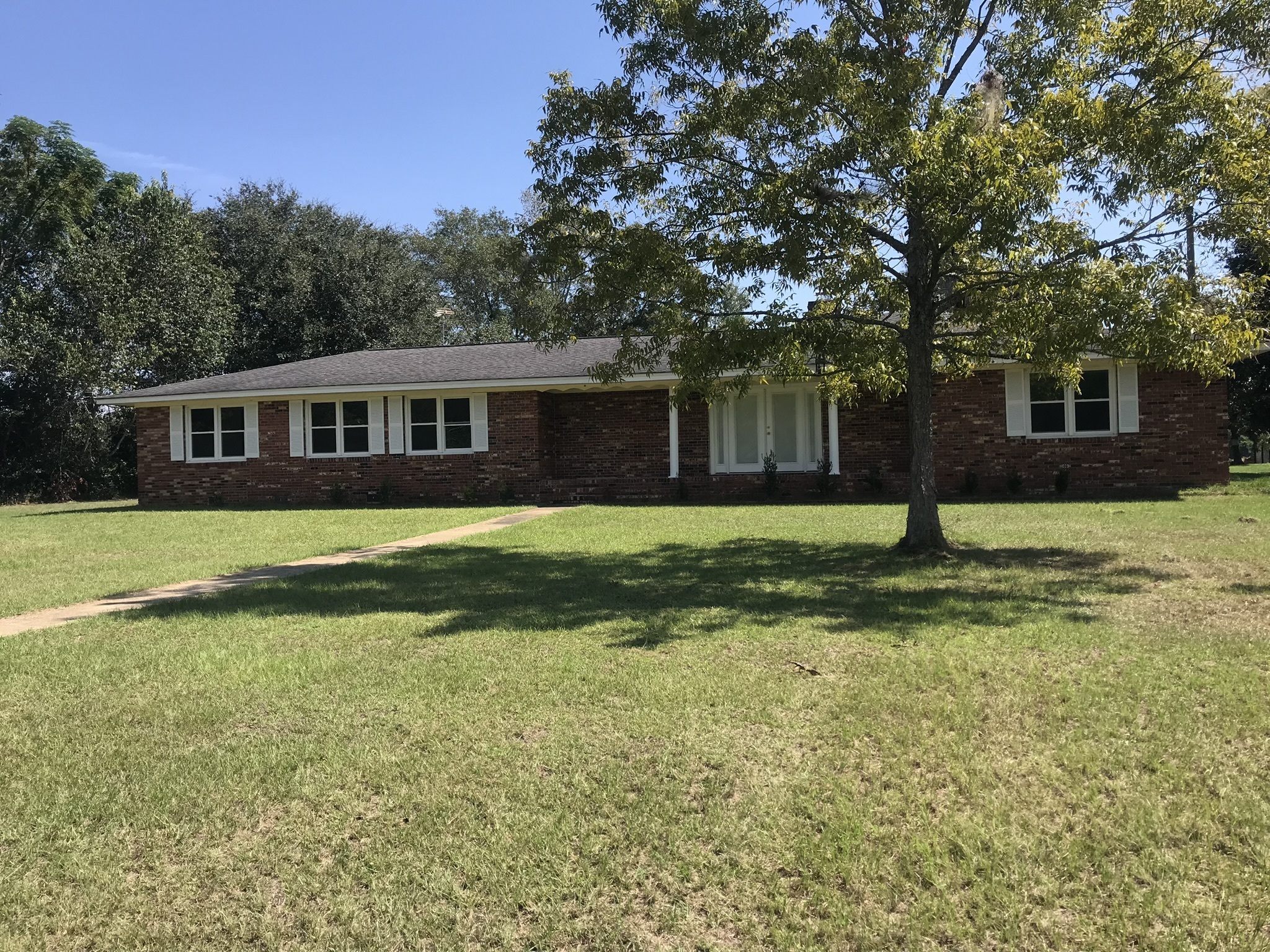 This is a nice 4 bedroom and 2 bathroom home sitting on 2.81 acres. The spacious kitchen has tile flooring, a stainless refrigerator, and opens up to the living room. The living room has a fireplace. One of the bathrooms has a double vanity. Both bathrooms offer plenty of counter space! The home does need a little TLC, but this property has a lot of potential.