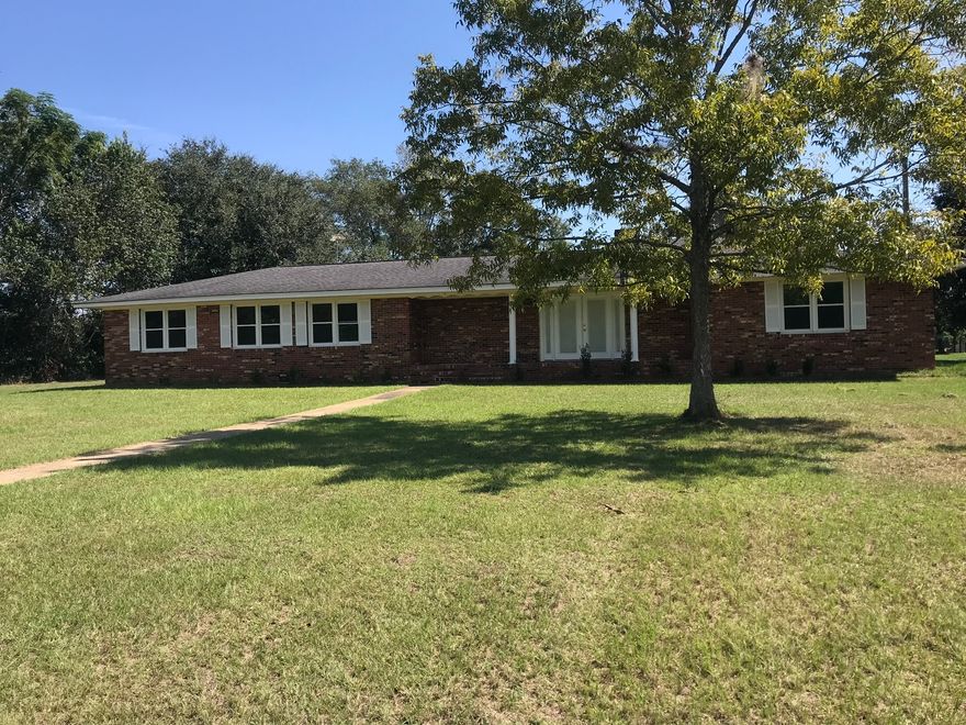 This is a nice 4 bedroom and 2 bathroom home sitting on 2.81 acres. The spacious kitchen has tile flooring, a stainless refrigerator, and opens up to the living room. The living room has a fireplace. One of the bathrooms has a double vanity. Both bathrooms offer plenty of counter space! The home does need a little TLC, but this property has a lot of potential.