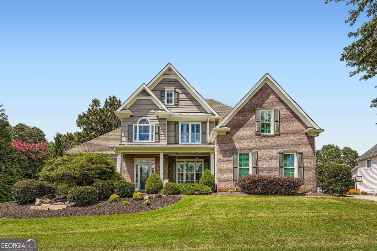 Welcome to 405 Dogwood Way, located in the highly sought-after BridgeMill neighborhood. This meticulously maintained and extensively upgraded home offers the perfect blend of upscale design, spacious living, and outdoor amenities ideal for entertaining. Inside, you'll find a completely renovated designer kitchen featuring custom cabinetry, high-end appliances, and modern finishes. The owner's suite is conveniently located on the main level, and all bedrooms throughout the home are exceptionally spacious. Additional interior upgrades include new windows across the front of the home, fresh interior and exterior paint, and a 3-car garage. The backyard is a true highlight of the property, designed for both relaxation and recreation. It features a zero-entry heated gunite pool and spa with smart controls, a full sand volleyball court with sand imported from 30A, and an expansive patio space perfect for hosting guests and parties. This home is located in BridgeMill, one of Cherokee County's premier communities, offering access to a full suite of amenities including a championship golf course, swimming pools, tennis and pickleball courts, a fitness center, on-site restaurant, parks, walking trails, and year-round social activities. Conveniently situated just minutes from Lake Allatoona, residents can enjoy access to multiple marinas including Little River Marina, and the nearby restaurant famously featured in the television show "Ozark", J.D.'s on the Lake This property combines refined interiors, resort-style outdoor living, and a vibrant community lifestyle in one exceptional offering. Don't miss out! Schedule your showing today. A discounted rate (0.5% rate buy down) and no lender fee future refinancing may be available for qualified buyers purchasing this home and using an affiliate of Orchard Brokerage, LLC.