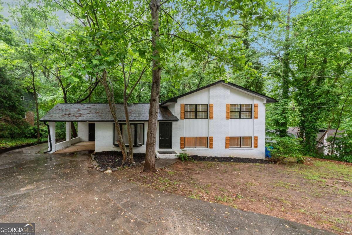 Welcome to 5786 Deerfield Trail - a beautifully renovated home located in the heart of College Park! This move-in-ready property offers modern updates, stylish finishes, and a spacious layout perfect for today's lifestyle. Step inside to discover an open and airy floor plan with fresh paint, brand-new flooring, and plenty of natural light throughout. The updated kitchen is a showstopper, featuring new cabinetry, granite countertops, stainless steel appliances, and a convenient layout ideal for cooking and entertaining. The home offers generously sized bedrooms and fully updated bathrooms with modern tilework and fixtures that give a fresh, contemporary feel. The primary suite includes its own private bath and ample closet space for added comfort. Outside, enjoy a large backyard-perfect for hosting gatherings, relaxing, or creating your own outdoor oasis. The home also includes a private driveway and carport/garage for added convenience. Located just minutes from major highways, shopping, dining, and Hartsfield-Jackson Airport, this home combines suburban comfort with city access. Don't miss your opportunity to own this stunning, turn-key home in a well-established neighborhood. Schedule your showing today!