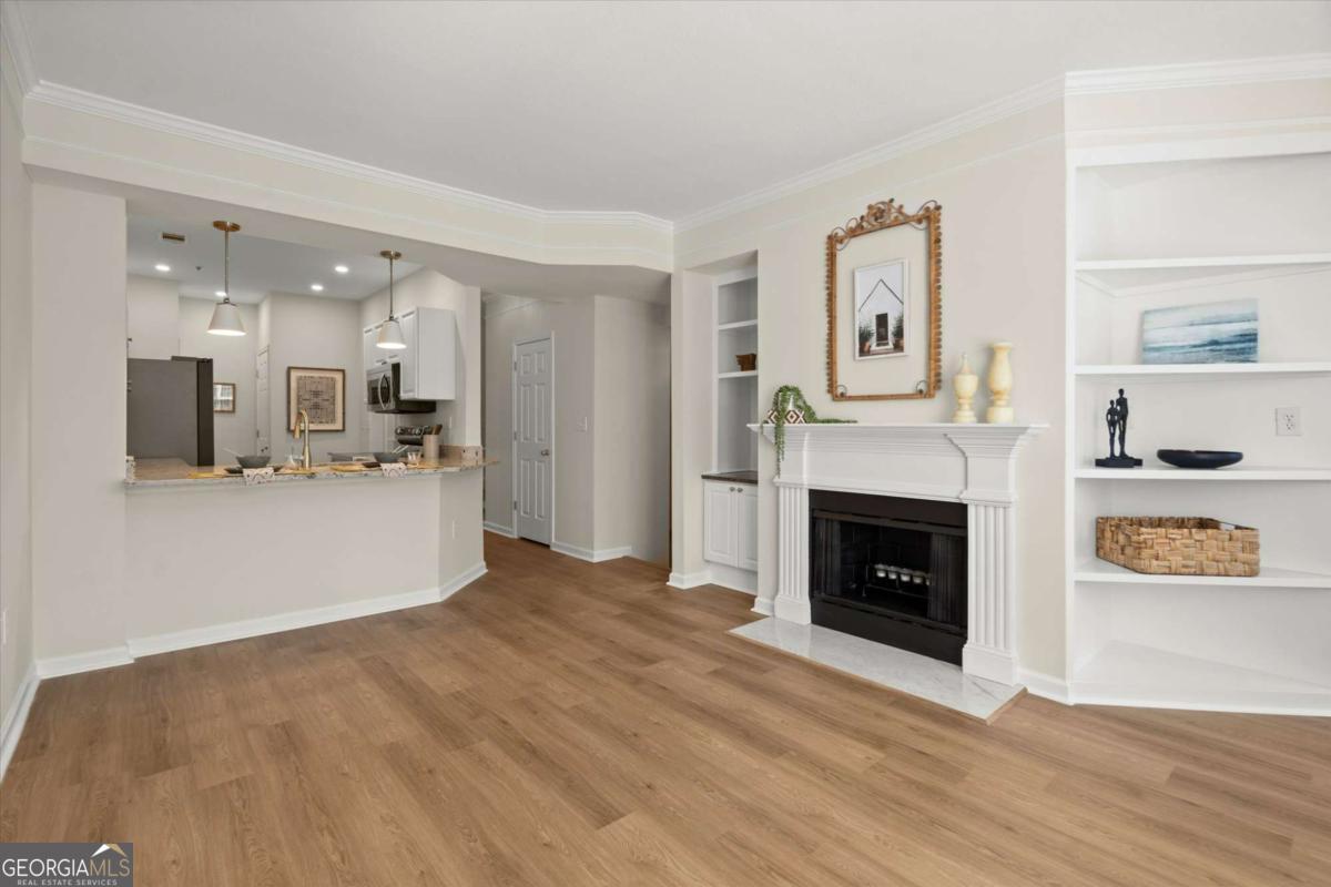 Updated 2BR/2.5BA Condo in Desirable Milton/Alpharetta - Resort-Style Living! Appraised for $370,000 - Instant Equity! Welcome to this beautifully updated 2-bedroom, 2.5-bathroom condo in the highly sought-after gated community of The Villages of Devinshire! Offering resort-style amenities at an affordable HOA fee, this home combines modern updates with a comfortable, convenient lifestyle. With 1,750 sq. ft. of living space, this home features 9-foot ceilings, brand-new easy-care LVT flooring on the main level, fresh paint throughout, and new carpet in the bedrooms. The spacious kitchen includes a breakfast bar that overlooks the living room, white painted cabinetry, new granite countertops, and all-new stainless steel appliances. A pantry closet and additional storage are conveniently located nearby. The stylish new brass faucet and pendants add a chic touch to the space. The living room, with a cozy fireplace and built-in bookcases, overlooks the lush trees, creating a serene and tranquil atmosphere. Adjacent to the living room is a flexible space perfect for a reading nook or home office. The separate dining room can accommodate a table for 6-8 guests and leads out to a rear deck, complete with a new ceiling fan for added comfort. The main floor also features a charming powder bath with wainscoting and wallpaper by Erin & Ben Napier (HGTV's Home Town), along with new lighting, mirror, and a Kohler toilet. Upstairs, the generously sized primary bedroom boasts dual walk-in closets, a tray ceiling, and a cozy reading nook with tree-top views. The attached bath is a true retreat, featuring dual vanities, a newly tiled walk-in shower, and updated lighting, faucets, and mirrors. The secondary bedroom also offers a tray ceiling, a walk-in closet, and an attached bath with a new tub/shower system, Kohler toilet, and updated fixtures. For ease of use, the laundry room is located on the bedroom level. For added peace of mind, the home includes a sprinkler system, smoke/carbon monoxide detectors, and a private one-car garage with direct access to the home. Guest parking is plentiful in the adjacent parking lots. Recent upgrades include two new HVAC units (2019) and a new water heater (2025). The Villages of Devinshire community offers an array of top-notch amenities, including a private pool, tennis/pickleball/basketball courts, gym, billiards room, and walking trails. The clubhouse is available for resident events, and a designated car wash station with a vacuum is on-site. With easy access to GA-400, you're just minutes away from Avalon, Halcyon, downtown Alpharetta, and the Verizon Wireless Amphitheater for entertainment, dining, and shopping. The Redline MARTA station is also nearby, making commuting a breeze. Don't miss the chance to call this stunning condo home Co schedule your showing today!