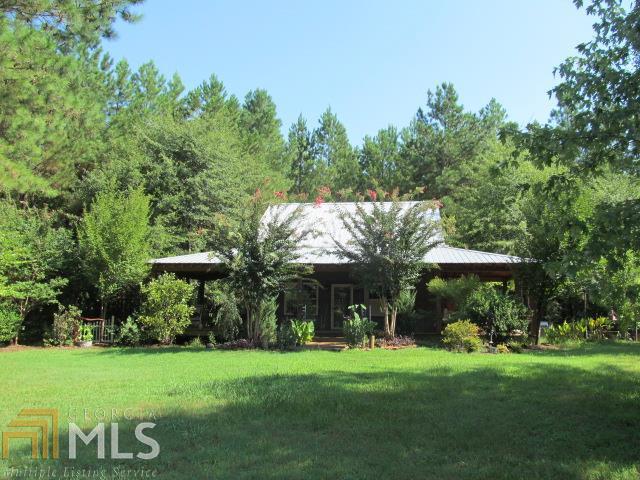Two bedroom two bath rustic home on 5.25 private acres. Beautifully landscaped with a huge covered front porch to enjoy your privacy from. Home could be three bedrooms. Home needs interior finishings but all the hard work has been done for you! If you are looking for a home to make your own come see this today!