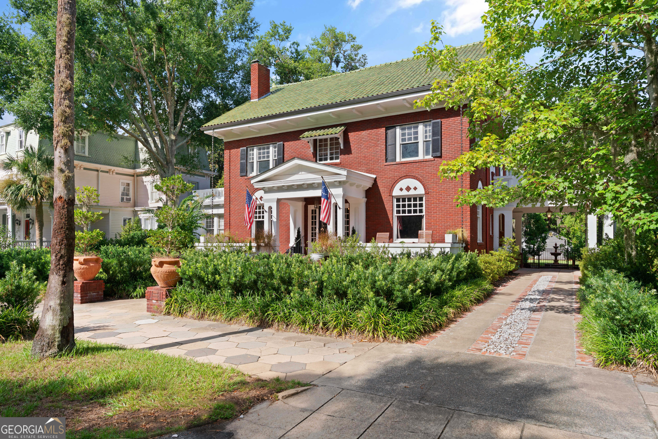 Built in 1913, this lovely home features beautiful hardwood floors, fireplaces and and a completely updated kitchen. Oversized kitchen has been updated to keep the charm but add the convenieces of modern day living. Complete with a breakfast nook and separate coffee bar, this kitchen truly is the star of the show including incorporating the original 2 sided fireplace that adds character and warmth. It is one of the few homes in the area that has a true full size basement. The home embodies southern charm with its inviting rocking chair front porch and timeless appeal. Inside, you'll find five spacious bedrooms, a formal sitting room, a casual family room, and an elegant dining area-perfect for both everyday living and entertaining. Situated on .37 acres with a back entrance off Reynolds Street, the oversized backyard offers plenty of space for a pool and an in-law suite if desired. This property exudes character and charm that are truly unsurpassed. Foundation has been professionally reinforced for added peace of mind. Check out the video on line at https://youtube.com/shorts/QI1QWnGYlGo