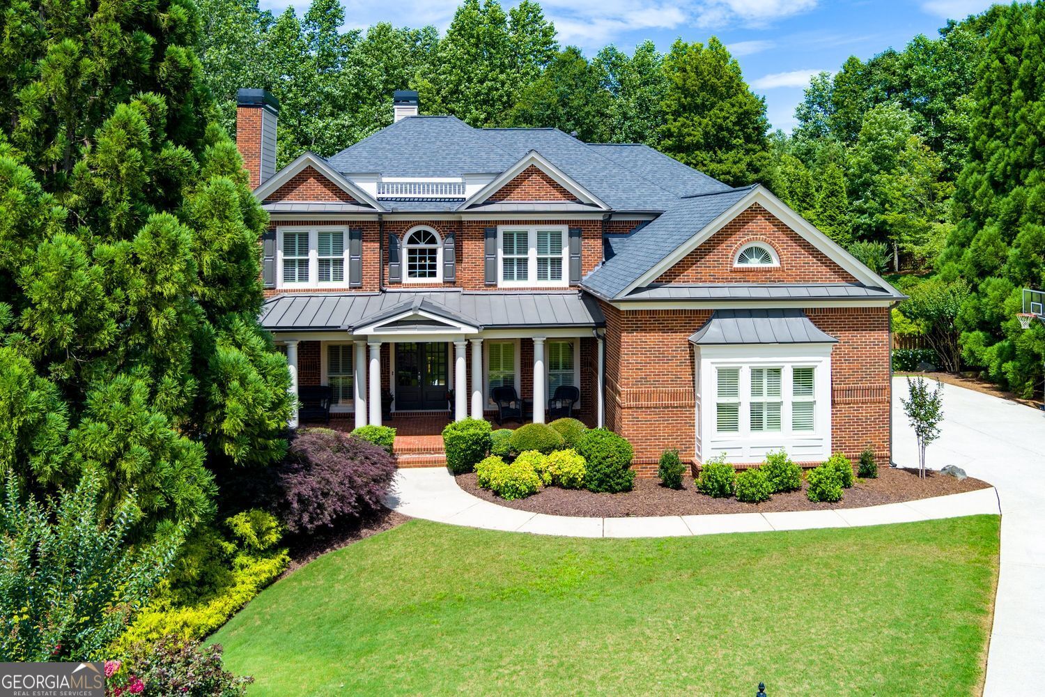 Stunning 3 side brick traditional home in a CUL-DE-SAC in Woodstock located in sought after Olde Heritage subdivision on almost an acre wooded lot. Just four miles from downtown Woodstock! This amazing home is filled with fabulous upgrades including double front doors, inviting 2-story foyer with beautiful dual staircases, office with cedar wood coffered ceiling, fireplace with custom mantle and built-in bookcases. Formal dining room with trey ceiling and stunning chandelier, butler's pantry off dining room. Grand two-story family room with wall of windows bringing in all of the natural light, complemented by a two-story soaring stone fireplace. The gourmet kitchen is a dream-featuring double ovens, an oversized island, casual dining area, walk-in pantry, new stainless steel gas cooktop and microwave. Custom laundry room with shiplap walls, cabinets, quartz countertops, brick floor and farmhouse sink. Step out to a dreamy screened-in porch with fireplace, cedar mantle, wood beams and tongue and groove ceiling overlooking a breathtaking private, wooded fenced in backyard This backyard is an oasis and a must see! Bedroom and full bath on the main level. Upgraded lighting throughout and plantation shutters on the front of the home. Three-car side entry garage. Upstairs you will find a serene primary suite that offers a sitting area with fireplace with shiplap accents, plus a fully renovated spa-style bathroom with marble tile in shower and quartz countertops. The primary suite also offers an expansive walk-in closet. Also on the upper floor: a private en-suite bedroom with full bathroom and two additional bedrooms with a shared full bath. The fully finished terrace level is made for entertaining or even a hang out spot for teens/in-law suite! Enjoy a coffered-ceiling family room, a custom bar, media room with theater seating, game space or pool table area, a mirrored fitness room with dual ceiling fans, a sixth bedroom and a full bath. The lower back patio features an outdoor kitchen and extended space-ideal for summer cookouts and fall gatherings. This home is filled with many improvements like: Two brand new HVAC's Fresh neutral paint and trim Tankless hot water heather Upgraded wide plank hardwood floors Fenced-in backyard Termite bond Newer exterior paint Roof replaced in 2018 Plantation shutters on the front of the home 4 fireplaces This home is immaculate!