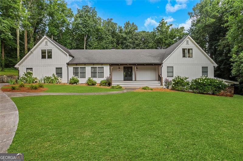 Welcome to 2244 Gunstock, a stunning custom estate tucked away on a quiet cul-de-sac in Smoke Rise. This elegant home offers over 5,000+ square feet of thoughtfully designed living space atop a full basement. Nestled on a private 1.7-acre lot, this home features a well-designed living space, a sparkling in-ground pool, and a host of thoughtful upgrades that make everyday living feel extraordinary. A charming rocking chair front porch and impressive double wrought iron doors set the tone as you enter the home. Inside, the main level features three spacious bedrooms, including a tranquil primary suite with French doors opening to the expansive back deck. The living room also features French doors that lead outdoors, creating a seamless indoor-outdoor flow perfect for entertaining or relaxing. At the heart of the home is a true chef's kitchen, fully equipped with high-end appliances, two dishwashers, double ovens, ice maker, warming drawer, pot filler, and an oversized island-perfect for hosting holidays or large gatherings. The space is designed for both beauty and function, offering abundant cabinetry and prep space. Just off the garage, a versatile flex room offers the ideal spot for a home office, butler's pantry, or additional laundry area. The adjacent sunroom features a wet bar with wine fridge, providing a stylish and functional space for entertaining or everyday enjoyment. Upstairs, you'll find two additional bedrooms, a spacious loft, and ample storage. The unfinished basement includes a full bathroom and exterior entry, offering tremendous potential for future customization-such as a media room, home gym, or in-law suite. Outside, the backyard is your own private retreat. The in-ground pool and spa were upgraded in 2021 with a new heater, salt cell, automation system, and multi-color LED lighting, all of which can be controlled directly from your cell phone. Whether you're hosting summer pool parties or relaxing in the spa under the stars, the setup is both beautiful and high-tech. And don't miss the cozy outdoor firepit area, ideal for cool evenings and gatherings year-round. This home combines functionality, comfort, and timeless design in an unbeatable location-close to parks, shopping, and major highways, yet privately tucked away in an established neighborhood.
