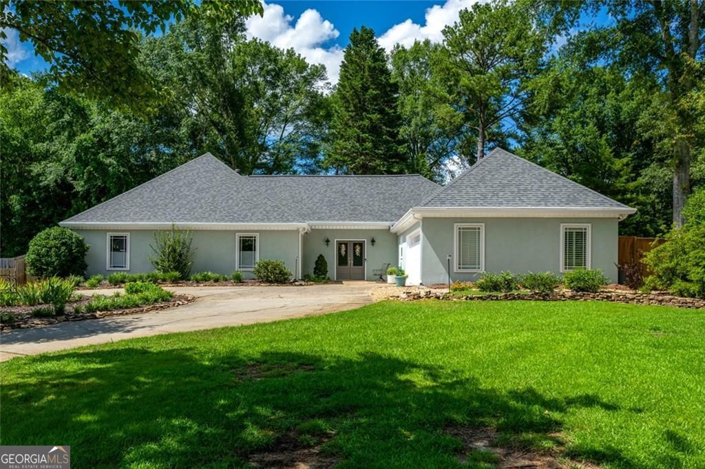 Splendid ranch living on an ideal lot, with a full luxury renovation complete for your enjoyment! The location is the cherry on top: a part of Downtown Alpharetta, easy access to EVERYTHING, and districted to 3 highly coveted schools. We are pleased to present this uncommon true ranch for your consideration! Although the floor plan showcases distinct living room, dining room and kitchen, they are connected seamlessly for maximum enjoyment. Gorgeous vaulted living space with cozy stone fireplace. Luxurious kitchen with all the latest fittings: quartz counters, full overlay cabinets, stylish backsplash taken to the ceiling, beautiful lighting, Walk in pantry with wood shelves. New LVP floors throughout the home in the perfect stain color. Updated powder room. Wander to the primary suite; remodeled to impress! New vanity, quartz counters, all new walk-in shower with frameless glass, and fashionable tile. 2 other bedrooms en suite to a jack-n-jill renovated bath. Check these off your to-do list: new front door, new hardcoat stucco, replaced double pane windows, almost new tankless water heater, expanded electrical panel. Enjoy the breathtaking yard from the patio: large, level, fenced, landscaped with sun drenched grass and a perimeter of hardwoods. Ideal scenario if you are dreaming of leveling up your backyard amenities to add a pool, screened porch or outdoor kitchen! New storage shed. Charming Andover North boasts a community pool and playground. Come enjoy the good life on Dover Ave.