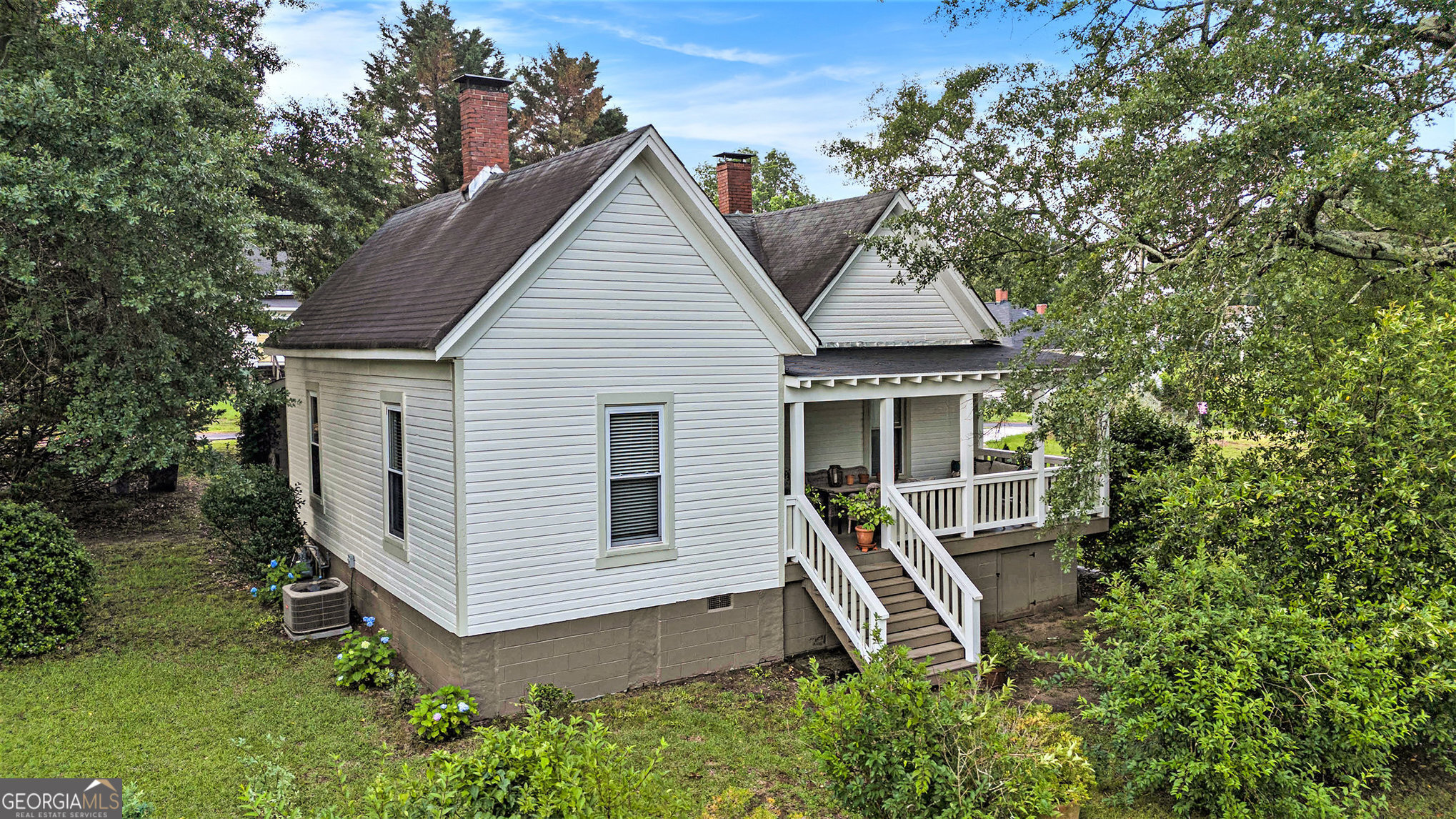 Welcome to this beautifully restored Porterdale mill cottage, ideally located in the heart of the historic districtCoa warm and inviting home just waiting for its next chapter. Lovingly maintained by its current owners, this residence is far from your average builder-grade home. Every detail reflects thoughtful investment, quality craftsmanship, and enduring careCono corners were cut, and no inexpensive materials were used. The charm begins with original beadboard walls and ceilings, complemented by refinished heart pine floors and a spacious open-concept layout anchored by a double-sided working fireplace. The kitchen is both stylish and functional, featuring stainless steel appliances, quartz countertops, a large pantry, and abundant storage space. The expansive front porch is designed for true Southern living, offering ample space for both lounging and dining, with plenty of room for a grillCoperfect for enjoying evenings with family and friends. Renovated in 2019, the home includes a full electrical rewire to code, new HVAC and ductwork, a rebuilt chimney and fireplace, a newly added en-suite primary bedroom, and a reimagined second bathroom with laundry. The entry from the carport was redesigned to include a welcoming foyer, and the carport itself was refurbished. A new roof and a separate storage building were also added. Additional storage can be found in the attic and beneath the home. The exterior was freshly repainted in 2024. Set in a peaceful, family-friendly neighborhood, this is more than just a houseCoitCOs a home thatCOs been nurtured with love and care, ready to welcome a new family to grow and make lifelong memories.