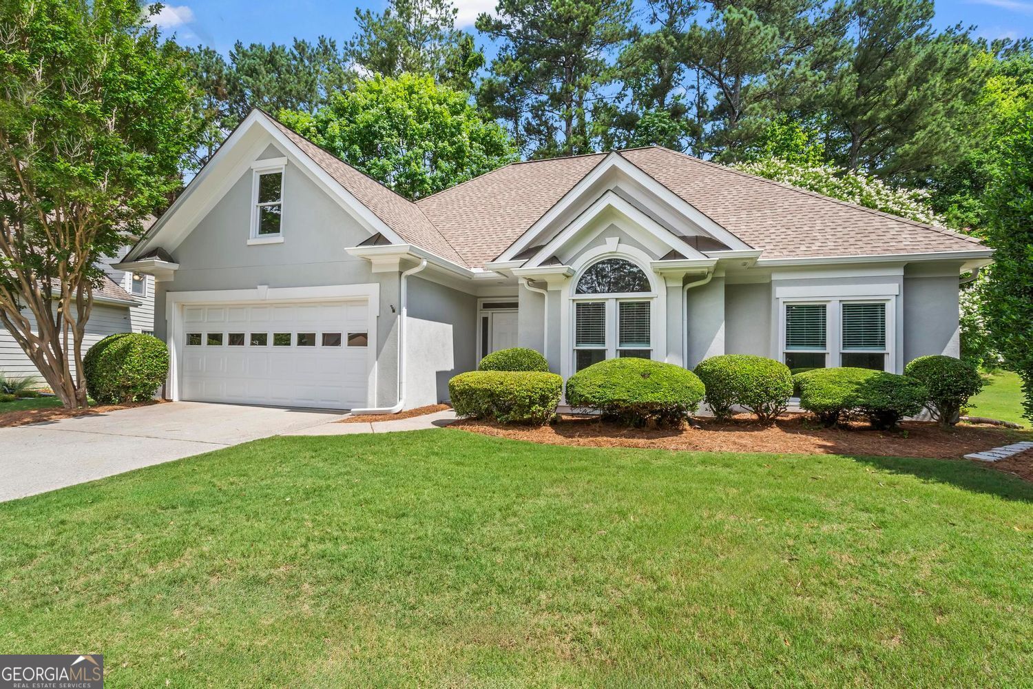 Look No Further-One-Level Living at Its Finest! Welcome to this stunning ranch home in the sought-after Graystone of Windward community in Alpharetta! Featuring a spotless quartz kitchen with an updated backsplash, stainless steel appliances, and gas cooktop, this home is designed for easy living. The charming eating area overlooks the private backyard and vaulted fireside great room. The primary suite boasts a spacious private bathroom with double vanity, separate garden tub and shower plus large walk in closet. Two additional bedrooms, one bedroom enjoys custom built-ins designed for an office or bedroom. Thoughtful upgrades include ceiling fans, blinds, and convenient walk-up attic access with ample storage and large two car garage. Step outside to enjoy the large private fenced backyard and patio. Conveniently located off Windward Parkway, just minutes away from Avalon, Alpharetta City Center, shopping, dining, and more, this home has been maintained to perfection. Windward Enjoys World Class Amenities Where Dreams Live! 195 Acre Private Lake, available to all residents. Sports Park with Fantastic Playground, Basketball Court, Gazebo, Dog Park, Community Garden and so much More! Optional Swim/Tennis at Windward Lake Club Top-rated, award-winning schools complete this exceptional opportunity!