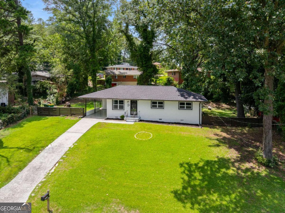 Discover your perfect home with this move-in ready, charming all-brick ranch! Featuring beautiful hardwood floors throughout, this home offers a spacious eat-in kitchen with granite countertops, a gas range, and stylish shaker cabinets. The updated bathrooms add a contemporary touch, ensuring comfort and convenience for you and your family. Enjoy the private, fenced-in yard, perfect for relaxation or entertaining, along with the added convenience of a carport. Located just a short drive from the airport and vibrant Atlanta, this home ensures easy access to all your needs. Embrace the blend of charm and modern amenities-schedule your visit today and make this welcoming residence your new home!
