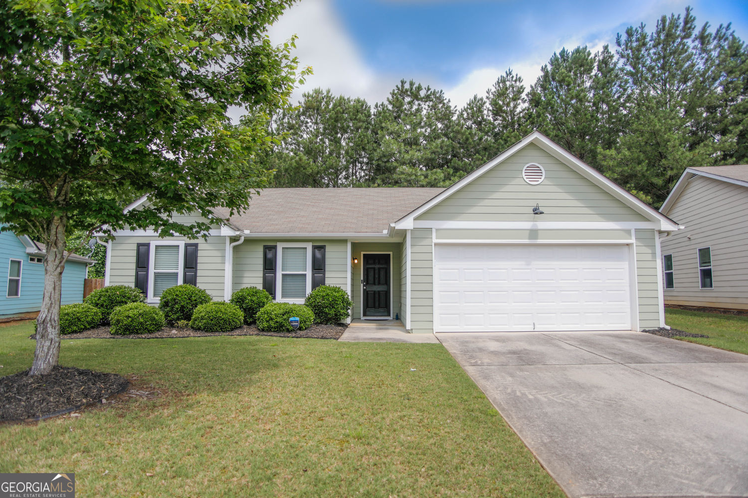 Welcome to Vineyard Gate. Move-in ready ranch home that backs up to wooded private space. This home features a true owner suite with full bath and walk-in closet. Plenty of room for large furniture. Cozy and welcoming. Second full bath is shared by the two secondary bedrooms. Wide hallways throughout, level driveway and easy entry to kitchen from garage. No steps to the front porch, into the home, or from the living area to the back patio. The large living area is open to the kitchen and the breakfast room/dining area. Back patio is a great retreat, with no homes behind. Privacy fence in back yard. Homeowners association with sidewalks and street lights, overflow parking for guests. MUST SEE! HOA covers trash pickup, yard maintenance, street lights and overflow parking. Lock and leave lifestyle with easy access to I-85. Braselton shops and restaurants are only 2 miles away, community gathering areas and a great walk/ride bike neighborhood.