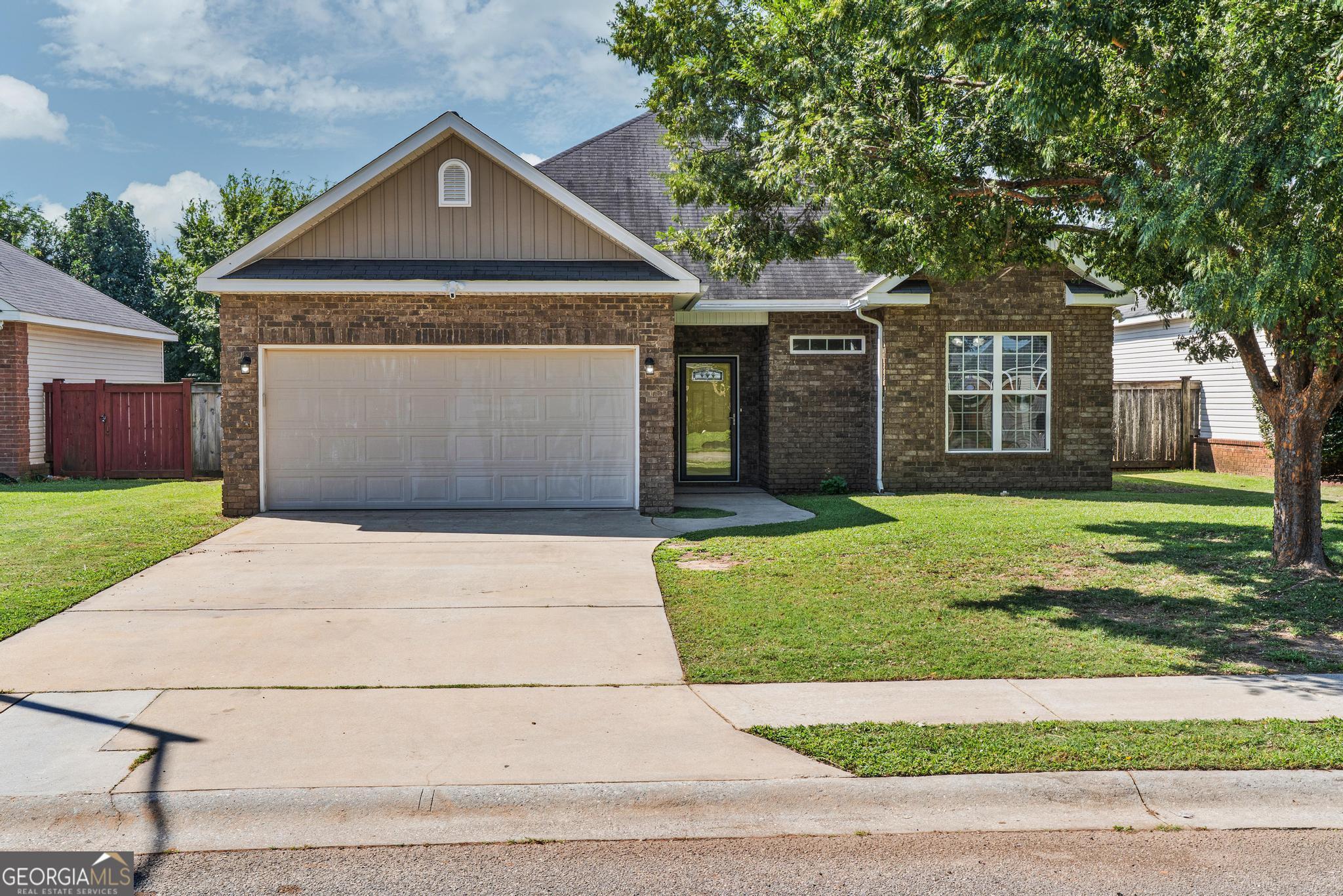 Welcome to your new home! Located in the serene Preston subdivision at 206 Amber Dr, this beautifully maintained 3-bedroom, 2-bath single-story residence offers 1,304 sq ft of comfortable living space on a private, fenced lot (6,534 sq ft) built in 2009. Elegant and spacious great room with laminate flooring and intricate molding details, stylish kitchen, fitted with custom two-tone cabinetry, tile backsplash, and black appliances - perfect for gathering and entertaining. Cozy master suite complete with garden tub, separate shower, and a curated vanity. Functional extras including a covered back porch, attic storage, ceiling fans, sprinkler system, and unobtrusive underground utilities, heat pump and central HVAC, plus a large 2-car attached garage. Enjoy the privacy and comfort of no rear neighbors, while still being just minutes from I-75 and Robins AFB. The community charms with a playful gathering area and is served by convenient schools in a thriving small-town community just a short drive from major metro amenities