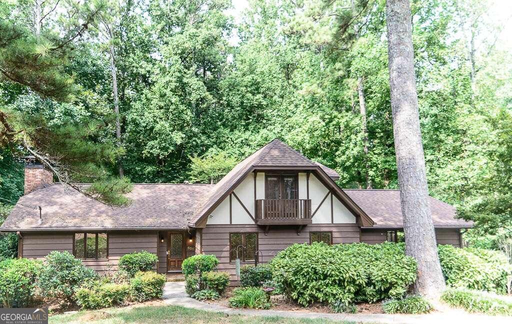Charming 3-Bedroom Home with Finished Basement in Brookwood School District Nestled in the desirable Brookwood School District, this lovely 3-bedroom, 2.5-bath home offers the perfect blend of comfort and style. The main level features a bright and open living room with charming exposed wood beams, leading to a screened-in porch that overlooks a large, wooded backyard-ideal for entertaining or simply enjoying the serenity of nature. The well-appointed kitchen boasts wood cabinets, granite countertops, a large island, and gleaming hardwood floors, making it a chef's delight. The primary bedroom is conveniently located on the main level, offering privacy and easy access. It features beautiful hardwood floors, while the en-suite bathroom includes a luxurious all-tile shower. Upstairs, you'll find two spacious bedrooms, each with built-in bookshelves, and a full bath. The finished basement is a true standout, featuring a stylish bar, a cozy wood-burning fireplace, and a large area perfect for a game room, complete with its own separate entrance. With its inviting spaces, thoughtful layout, and prime location, this home is a must-see. Schedule your showing today!