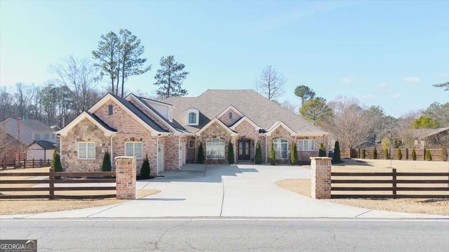 Exquisite Custom-Built 4-Sided Brick Home in East Cobb's Top School District!  Discover unparalleled craftsmanship and luxurious living in this stunning custom-built, four-sided brick home, situated on nearly an acre in the highly sought-after East Cobb school district with the benefit of low Cobb County taxes. Showcasing the finest finishes and superior construction, this home is a true masterpiece!  From the moment you arrive, the impressive curb appeal sets the tone. A gated entrance leads to a wide driveway, offering ample parking for multiple vehicles. Built just five years ago, this residence boasts impeccable design and high-end features throughout, promising a lifestyle of elegance and comfort.  Step inside to an inviting open floor plan that seamlessly blends the living room, dining area, and kitchen creating the perfect space for both entertaining and everyday living. Large windows flood the home with natural light throughout the day, while soaring ceilings enhance the sense of space and openness.  The heart of the home is the fully equipped chef's kitchen, complete with an oversized center island ideal for hosting or casual dining. Gleaming quartz countertops, abundant cabinetry, top-of-the-line stainless steel appliances, and a spacious walk-in pantry provide both beauty and functionality.  The expansive living room features a stunning fireplace as its focal point, adding warmth and elegance to the space. The oversized owner's suite is a private retreat, boasting gorgeous tray ceilings, bay windows, and a spa-like en-suite bathroom with a jetted soaking tub and a large, frameless glass shower.  Three additional generously sized bedrooms on the main level each come with their own en-suite bathrooms, ensuring ultimate comfort and privacy for family and guests.  Upstairs, you'll find a full apartment-like suite, complete with its own living room, entertainment area/home theater, an additional bedroom, and a full bathroom perfect for extended family or guests.  Step outside to the gorgeous covered back patio, an outdoor oasis where you can enjoy your morning coffee in peace or unwind with a glass of wine at the end of the day.  Practicality meets luxury with a spacious three-car garage, designed to accommodate vehicles of all sizes while still providing plenty of storage. Additionally, the detached covered parking area offers the perfect space for your RV or boat.  And let's not forget location is everything! Situated right off Sandy Plains Road and Piedmont Road, this home is just minutes from I-75 and I-575, within walking distance to top-rated schools, shopping, dining, and entertainment.  Don't miss your chance to own this exceptional retreat schedule your private tour today!