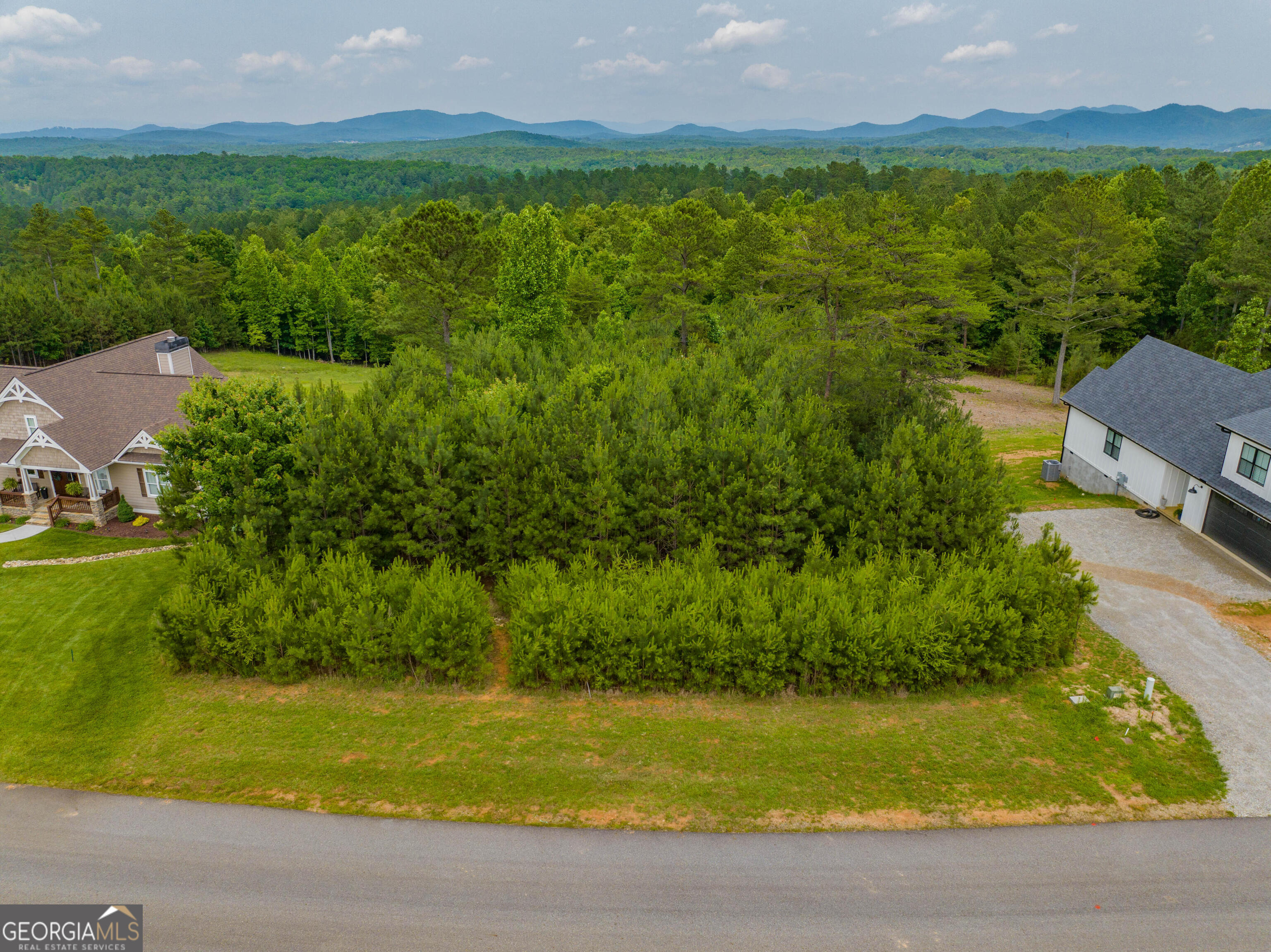 Escape to serenity on this exceptional 1.51-acre homesite within the coveted gated community of Thirteen Hundred Subdivision, where luxury living meets lakefront recreation. This prime parcel combines privacy, natural splendor, and endless possibilities for creating your custom sanctuary, surrounded by rolling terrain and mountains that provide the perfect backdrop for your architectural vision. This gentle sloping lot offers a blank canvas with unlimited potential for your custom home design. Residents enjoy exclusive access to premium community amenities including a swimming pool, elegant clubhouse for entertaining and events, and a private marina on beautiful Nottely Lake for boating and water recreation. This rare offering represents more than just land - it's your gateway to a lifestyle of refined country living with resort-style amenities, where natural topography and mature surroundings create an ideal canvas for both traditional and contemporary home designs. Take action today to explore this exceptional opportunity and begin crafting your future in the distinguished Thirteen Hundred community!
