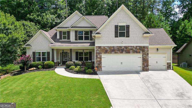 This lovely 4 bedroom, 2 1/2 bath home is located in the desirable Sedgefield Community in Dallas, Georgia. The home greets you with a gracious open floor plan, abundant natural light, and beautiful finishes throughout. The Great Room is remarkable- featuring soaring ceilings and a 2-story stacked stone fireplace. This gathering space is inviting and will set the cozy atmosphere for many memorable Holidays ahead! The Primary Bedroom is ideally located on the main level, and the additional bedrooms are on the second level of the home. The Primary Bedroom also offers dual walk-in closets and dual vanities as well. The chef's Kitchen is the perfect place for all to gather around the large island. The Breakfast Nook is situated within the open Kitchen to offer an additional option for dining. With natural stone countertops, stainless steel appliances and a gas range, this Kitchen is sure to be the heart of the home! Additional features of this home are a dedicated Laundry Room, hardwood floors on the main level, a Covered Patio that is perfect for entertaining, a large walk in Pantry and a formal Dining Room with a beautiful architectural trimwork. The backyard offers terraced landscaping, complete with lovely established rosebushes, lilies and peonies- with twinkling solar lights for evening enjoyment of your peaceful retreat. The storage shed off to the side is perfect for additional storage of garden tools, as well. One of the most exciting attributes of this home is the large epoxied 3-car Garage! It's perfect for accommodating larger vehicles due to its roomy dimensions. Complete with abundant task lighting and an electric vehicle charger- this Garage has to be seen in person! The Sedgefield neighborhood offers a Pool and Playground and is close to Costco, shopping and local trails. Inquire for further details and to schedule a showing!