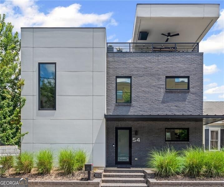 Welcome to your next chapter-where modern design meets the vibrant heartbeat of the city. Perfectly positioned on an accessible corner lot parallel to Boulevard SE, this home offers something rare: an electronic security fence for privacy and security, stunning downtown skyline views and the kind of craftsmanship you can feel the moment you step inside. From the very first glance, the architecture makes a statement-clean lines, high-quality construction, and a seamless connection between indoor and outdoor living. The main living level is a showstopper-soaring double-height ceilings flood the space with light, while the private courtyard garden creates a serene backdrop for everything from weekend brunch to lively evening gatherings. In the kitchen, form meets function with custom two-tone cabinetry, premium finishes, top of the line appliances, and an open flow that makes entertaining effortless. Whether you're hosting a dinner party or enjoying a quiet meal at home, this is where memories are made. Upstairs, the primary suite is your personal retreat-walk-in closet, additional custom built-in storage, and a spa-inspired bath featuring a soaking tub, and a frameless glass shower. Every detail designed with your comfort in mind. And when it's time to unwind or entertain in style, ascend to the third-floor rooftop terrace. Here, under an covered trellis, the city sparkles around you-paired perfectly with a wet bar for those unforgettable evenings. Step outside and you're just a short walk away from one of the most vibrant stretches of the BeltLine, with neighborhood favorites like Chrome Yellow Coffee, the O4W Dog Park at Fetch, and the iconic Staplehouse at your doorstep. Krog Street Market, Ponce City Market, parks, trails, and nightlife-all just minutes away. This is more than a home. It's a lifestyle. A place where design, location, and experience meet. And now-it's ready for you.