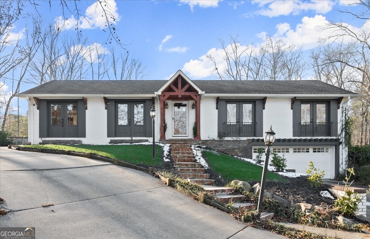 Welcome home to this gorgeously renovated, 4 sided brick ranch home on a full basement and nearly an acre lot with no HOA! Main floor is a bright, open floor plan made for easy living and amazing for entertaining. Newer white kitchen cabinets, stainless steel appliances, granite counters, subway tile backsplash and a large island facing living room will wow you! Living room is centered by cozy fireplace and has sleek built in bookshelf, and there's a generous space for dining. Off the back of the home is an expansive sunroom with another fireplace, makes for a large additional living or dining space and take in private backyard and Trex deck! Secondary bathroom down the hall has been recently renovated with new tile and vanity, and owners suite is something special. The primary bedroom offers a walk in closet and tastefully updated master bathroom with custom barn doors for both, and a charming window seat to overlook the back of the property. Lower level offers another living area and a 3rd (yes, 3rd!) fireplace, as well as a modern and beautiful laundry room and another secondary bedroom with recently renovated bathroom. The property has an enclosed yard right off the deck, and also the lot behind (can gain access by driveway path to right side of home), full of possibilities. There's an incredible amount of parking here with a gravel parking pad to the left of the home with tons of space for vehicles, boats, RVs, etc. And while it feels private and secluded, you're centrally located in East Cobb with all the perks (awesome schools, restaurants, shopping and more) with easy highway access as well as just 10 minutes from the Marietta Square!