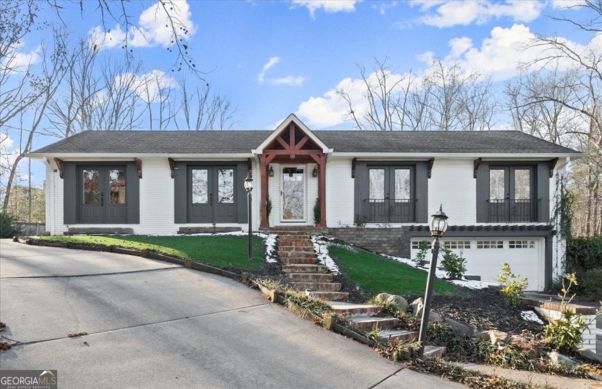 Welcome home to this gorgeously renovated, 4 sided brick ranch home on a full basement and nearly an acre lot with no HOA!  Main floor is a bright, open floor plan made for easy living and amazing for entertaining.  Newer white kitchen cabinets, stainless steel appliances, granite counters, subway tile backsplash and a large island facing living room will wow you!  Living room is centered by cozy fireplace and has sleek built in bookshelf, and there's a generous space for dining.  Off the back of the home is an expansive sunroom with another fireplace, makes for a large additional living or dining space and take in private backyard and Trex deck!  Secondary bathroom down the hall has been recently renovated with new tile and vanity, and owners suite is something special.  The primary bedroom offers a walk in closet and tastefully updated master bathroom with custom barn doors for both, and a charming window seat to overlook the back of the property.  Lower level offers another living area and a 3rd (yes, 3rd!) fireplace, as well as a modern and beautiful laundry room and another secondary bedroom with recently renovated bathroom.  The property has an enclosed yard right off the deck, and also the lot behind (can gain access by driveway path to right side of home), full of possibilities.  There's an incredible amount of parking here with a gravel parking pad to the left of the home with tons of space for vehicles, boats, RVs, etc.  And while it feels private and secluded, you're centrally located in East Cobb with all the perks (awesome schools, restaurants, shopping and more) with easy highway access as well as just 10 minutes from the Marietta Square!