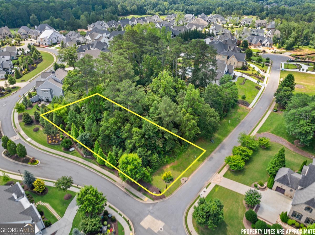 Situated within the prestigious gates of The Manor Golf and Country Club, this rare .65-acre corner lot offers the perfect canvas to build your custom luxury estate. Located in one of Milton's most sought-after communities, this lot provides an expansive footprint, allowing for a grand residence, pool, and outdoor entertaining space. A premier luxury builder is already in place, ready to bring your dream home to life with unparalleled craftsmanship and timeless design. Enjoy the privacy and prestige of this exclusive neighborhood, known for its world-class amenities including a Tom Watson-designed golf course, indoor and outdoor tennis facilities, aquatic center, fitness center, and clubhouse with fine dining. This is a unique opportunity to secure your place in one of North Atlanta's most elite communities. Custom plans available upon request.