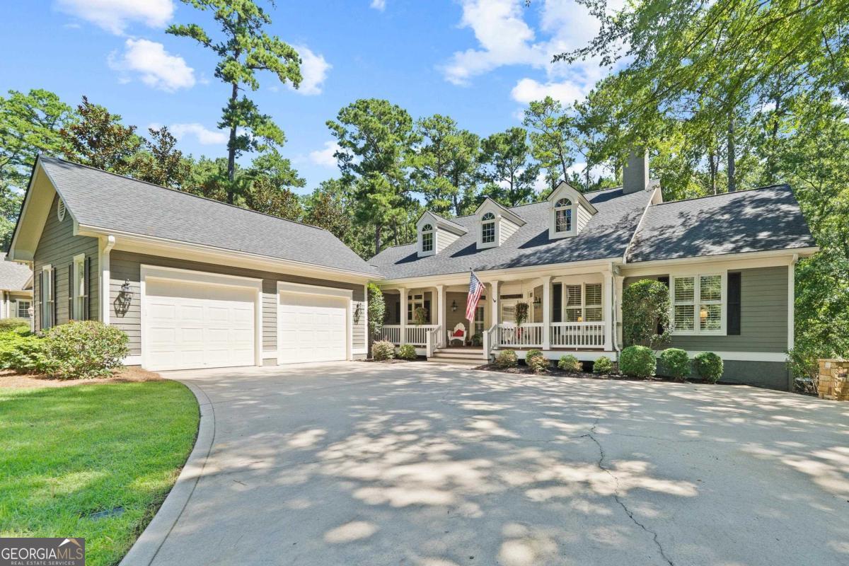 Don't miss this charming 24-Hour Lake Access Home in Reynolds Lake Oconee. Situated on almost an acre with an additional wooded Common Area in the backyard, the privacy is simply amazing. Whats even better is you're just a short Golf Cart ride to your assigned boat slip which is the gateway to start enjoying everything Lake Oconee has to offer. Inside, don't let the age fool you as renovations over time allow this 4 Bedroom 3.5 Bath home to be move in ready. An open floor plan is just what Buyers are looking for today and while the 4100 plus square feet offers comfortable living for a couple, rest assured there is enough room for all the visiting family & friends. Everyone is sure to enjoy the incredible Terrace Level Family Room that includes a Pool Room, a great Bar and an incredible Putting Green. And if you need more, don't miss the incredible Screened Porch and Terrace Level Patio which are 2 great spots to end the perfect day at Reynolds Lake Oconee. Seller is making a Club Membership available.