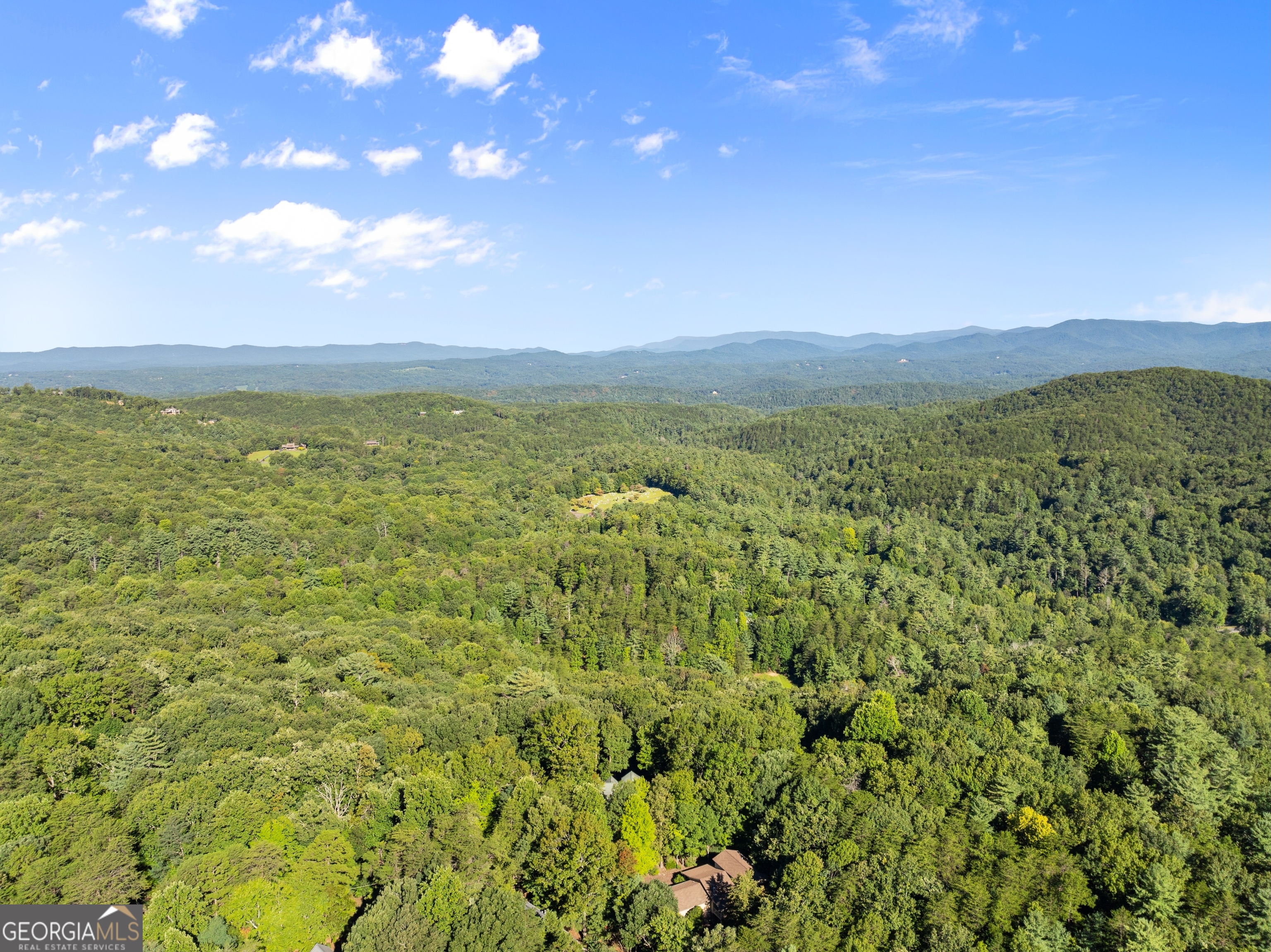 Bring your vision to life with this 0.55-acre lot in the highly desirable gated community of Walnut Mountain in Ellijay, GA! With 77 feet of paved road frontage and easy access, this property is ready for your dream home-just needs a soil test and a builder to begin. Community water is already available and conveniently included in the HOA dues, leaving only a septic system to be installed. Nestled in a well-established neighborhood, this lot offers a great location for full-time living, a peaceful part-time escape, or even a profitable vacation rental. Walnut Mountain is known for its natural beauty, security, and sense of community, making it one of Ellijay's most sought-after areas. Don't miss this chance to create your perfect mountain retreat! Right to the R of 133 Pine Ridge Road, Ellijay GA 30540. Map GPS to this address, see lot to R of this home. NO sign per the HOA. From Walmart in Ellijay, turn R onto Hwy 515 N. In 1.6 mi, turn L onto First Ave. In 600 ft, turn R onto Hwy 52 E. In 1.3 mi, turn L onto Turniptown Rd. In 3.7 mi, take a slight L turn onto Walnut Mountain Road. In 100 ft, turn R onto Walnut Mountain Road. In 0.7 mi, turn L onto Pine Ridge Rd. In 750 ft, the destination is on your L. Sign in place.