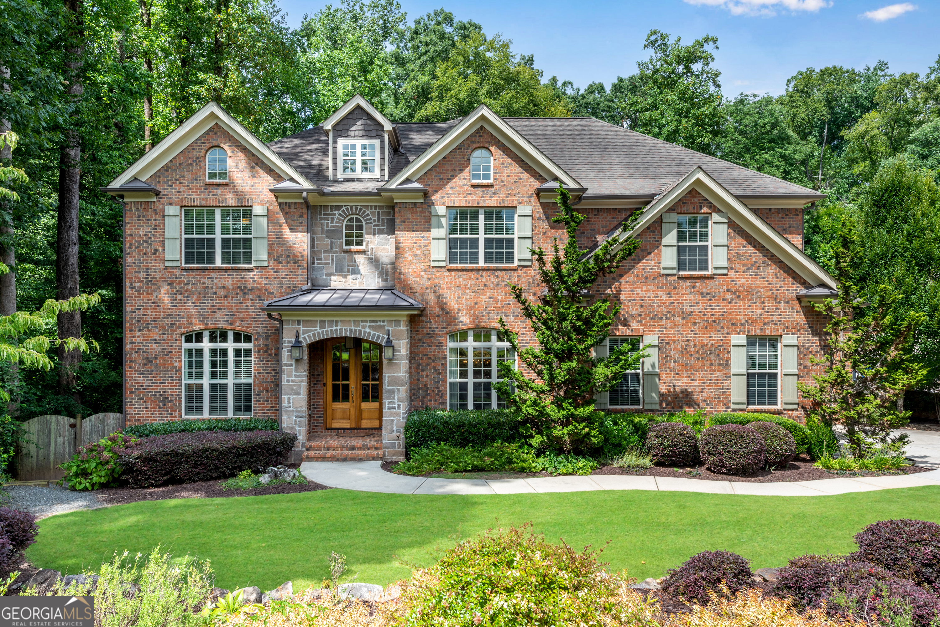Custom built, four-side brick home with expansive entertaining space and amazing, park-like backyard on quiet circle in desirable Dunwoody neighborhood. Six bedrooms with five full bathrooms. Chef's kitchen with stainless steel Thermador appliances and large island that looks out to private, serene outdoors. Main level with spacious great room that features 12-foot coffered ceiling, large dining room, guest suite as well as separate office. Generous primary suite with vaulted ceiling and sitting room, large upscale bath with oversized shower and inviting soaking tub. Enormous custom closet. Three additional bedrooms with two baths (including Jack and Jill). Second level with step-up bonus/craft/media room. Terrace level boasts of large second living area, fabulous media room, bedroom suite w/full bathroom, as well as second laundry room and workshop. Expansive Trex deck provides wonderful views of private backyard with wall-mounted TV. Separate rear screened porch with wood-burning fireplace is perfect for morning coffee or relaxing after-hours beverage. Under-deck, outdoor living space. Professionally landscaped, fully-fenced backyard features graveled area perfect for a firepit, wonderful herb garden and room for a swimming pool. Three-car garage. A short stroll to the restaurants and shops of Dunwoody Village, as well as nearby Brook Run Park, Marcus Community Center, Dunwoody Nature Center and Perimeter Mall. Join any of Dunwoody's popular swim/tennis clubs. Low voltage, structed wiring and ethernet throughout. A meticulously maintained one-owner home.