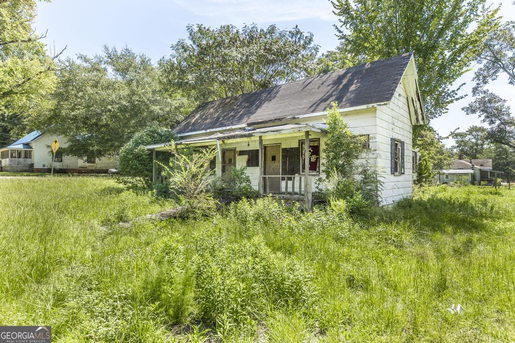 Discover the potential of this charming home, perfectly situated on a spacious lot with room to grow. Featuring solid construction and timeless architectural details, this property provides a wonderful opportunity for renovation and customization. The versatile floor plan offers a blank canvas, ready for your modern updates while maintaining its original character. The expansive yard provides endless possibilities-ideal for a garden, outdoor entertaining, or creating your own private retreat. With vision and creativity, this home can be transformed into a true gem and a lasting investment for the future. Don't miss your chance to reimagine this property and make it your own!