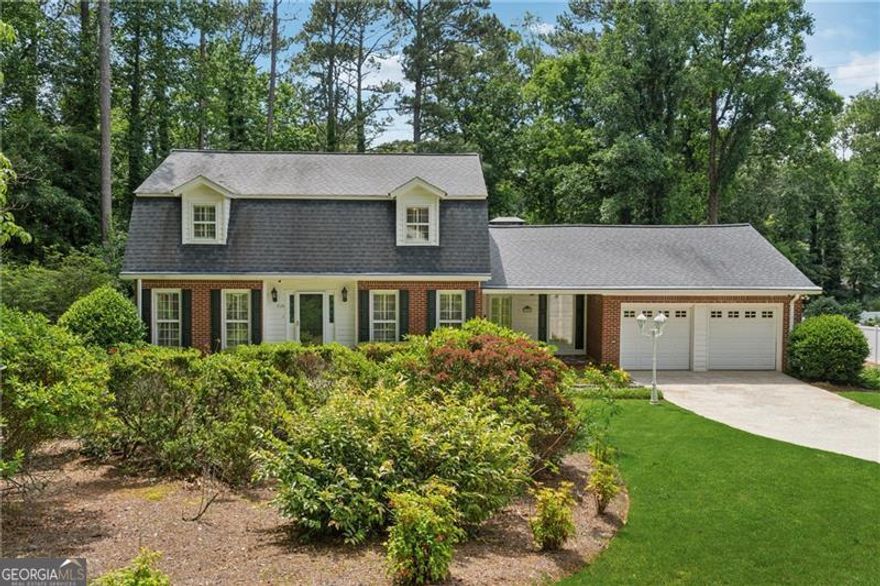 Nestled in the serene Cheatham Woods neighborhood, this delightful 4-bedroom, 3-bathroom home offers a perfect blend of comfort, convenience and curb appeal. The formal entry leads into a two-story foyer with hardwoods and chandelier. A second entry leads into the large vaulted family room with gas log fireplace. Also on the main are an updated kitchen with ample cabinetry, refrigerator, wall oven, electric cooktop, microwave and double sink; dining room open to formal living room; laundry; and bedroom with full ensuite. Upstairs the primary suite features a walk-in closet, ensuite with double vanity and walk-in shower. An updated hall bath serves two additional bedrooms. The master suite features an en-suite bathroom and generous closet space, while the additional bedrooms are perfect for family, guests, or a home office. Enjoy the beautiful backyard and deck. A shed with electricity provides additional storage, plus there is a two-car garage. The home is ideally located with easy access to the Marietta Square, Barrett Pkwy, Kennesaw Mountain parks and trails, and Cheatham Hill Elementary School. The lot is a spacious (approx.) half-acre and the sale includes the vacant lot next door of the same size, totaling approximately one acre. Don't miss the opportunity to make this charming house your new home in Marietta!