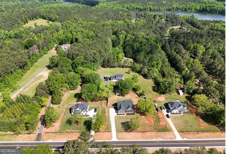 INSTANT 6 FIGURE EQUITY AND READY TO SELL OR BUILD! Welcome to this rare opportunity to own a fully updated and appraised home on almost 15 acres in the serene and sought-after Tussahaw Farms Subdivision. Walk into ample amount of instant equity. Whether you're looking for peaceful country living, an investment property, or a private retreat for outdoor adventures, this stunning estate has it all. This 3 bed and 3 full bath home has been meticulously renovated with new roof, energy-efficient windows, HVAC system, driveway, expansive decks, luxury flooring, fresh interior and exterior paint, exterior lighting, new well system, and a modern security system. It's truly move-in ready, offering comfort, peace of mind, and long-term value. The main level features a spacious mudroom/laundry room, a full bathroom connected to family room. This family room can also be used as an owner's Suite or Guest Suite, or a huge bonus room perfect for entertaining, gaming, or a home office. Upstairs, you'll find two oversized bedrooms, each with private en-suite bathrooms, including a luxurious primary suite that's a true sanctuary. Enjoy a spa-like en-suite bath with dual vanities and a frameless glass shower, perfect for unwinding after a long day. Step outside and discover a world of possibilities! The property includes a detached 3-car garage that can also be customized as a guesthouse, offering flexible space for visitors, short-term rental income, or multigenerational living-making this a fantastic investment opportunity. For outdoor enthusiasts, the land is ideal for those who enjoy hunting, fishing, trail rides, or even building additional homes. With plenty of open space, mature woods, and trails, this property caters to both recreation and expansion. Utilities include Cable, High-Speed Internet, Electricity, Phone, Propane, Underground Utilities, and Water Access-ensuring modern convenience in a peaceful, rural setting. Located in the heart of Locust Grove, just minutes from local amenities, dining, and shopping, yet surrounded by nature-this home offers the best of both worlds. Don't miss this one-of-a-kind opportunity to own a versatile, updated estate with income potential in Tussahaw Farms. Schedule your private tour today!